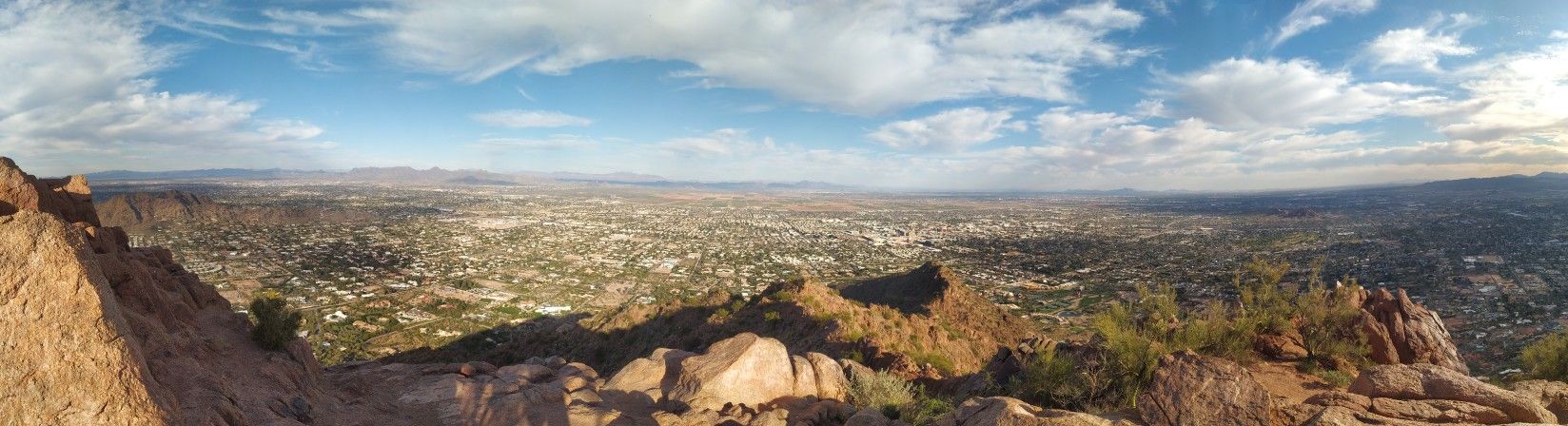 Panoramic city landscape from rocky mountain under a partly cloudy sky. - Hiking loop from Scottsdale