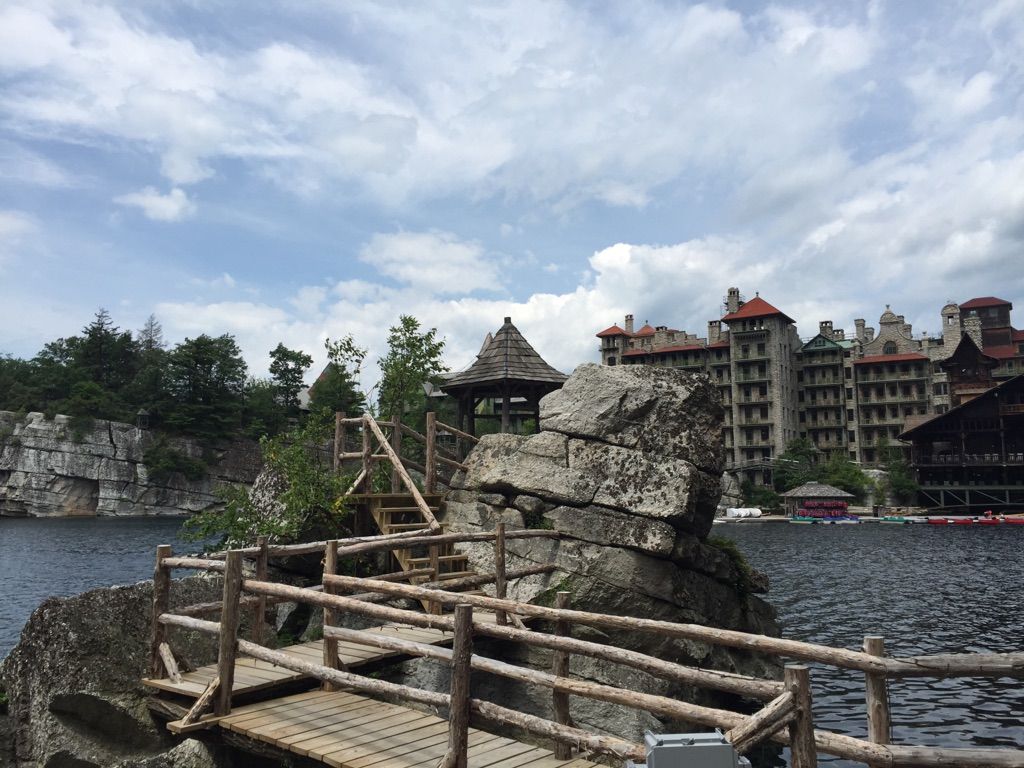 Wooden gazebo on a rocky island connected by a bridge over a lake. - Eagle Cliff and Mohonk Lake Trail