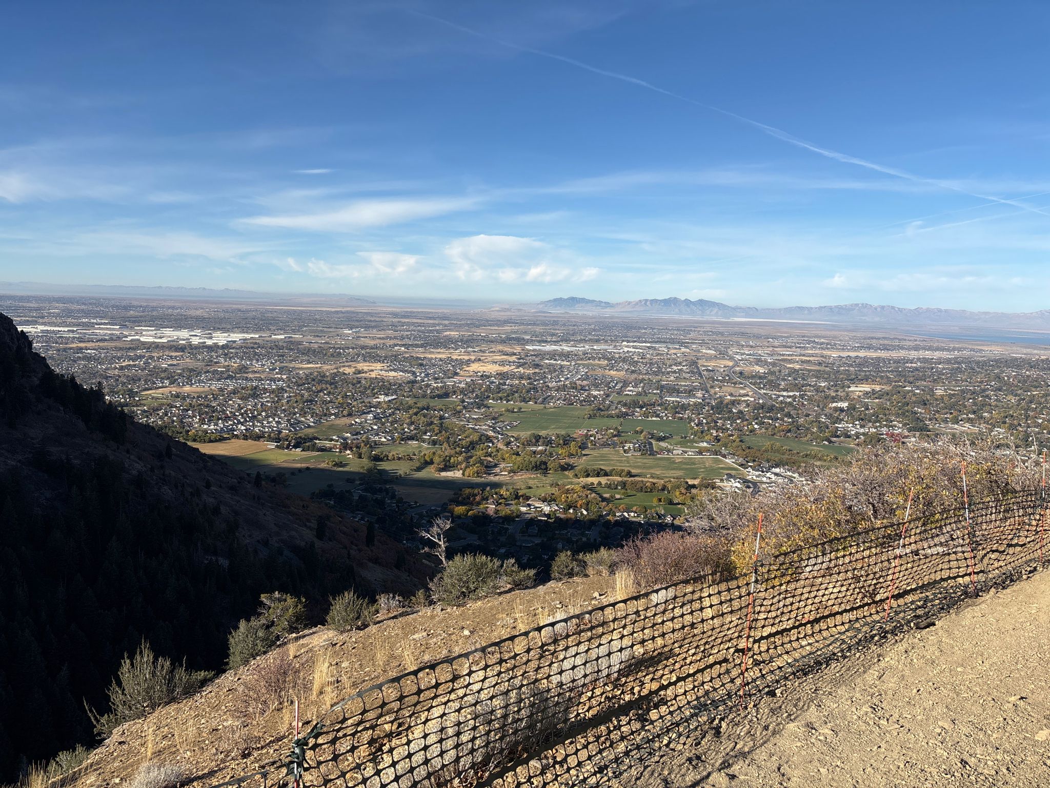 Panoramic view of a sprawling city from a dry hillside with a fence. - Coldwater Canyon BST