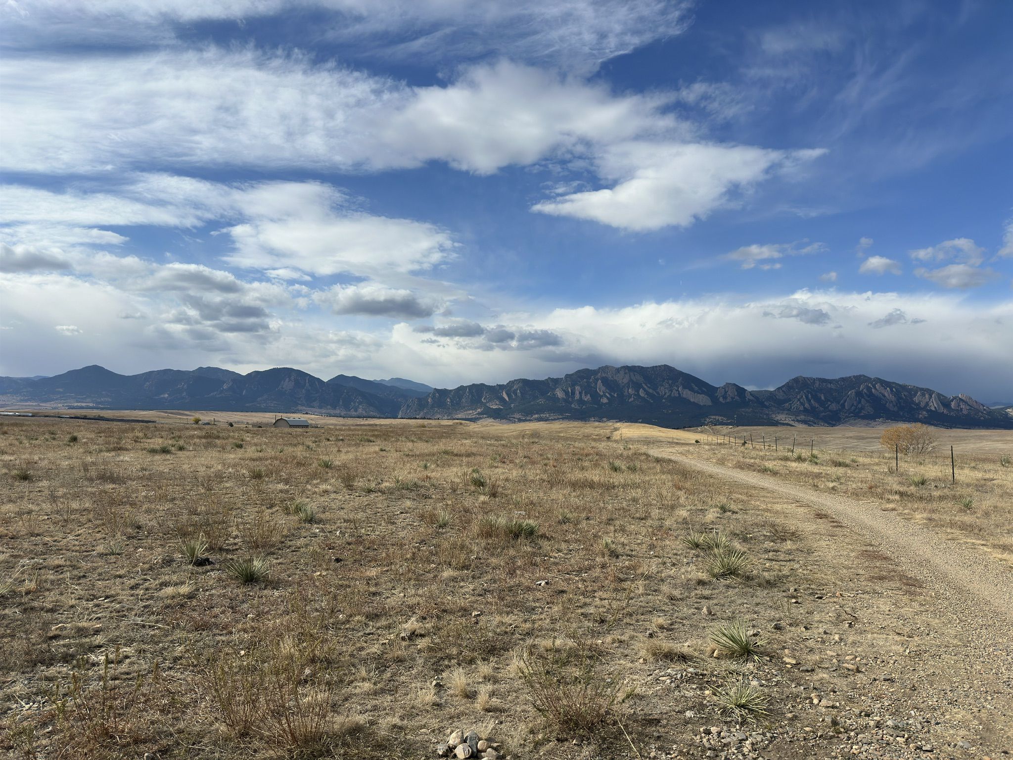 Dirt path through dry landscape with distant mountains under cloudy sky. - Mayhoffer Trail loop from Flatiron Crossing