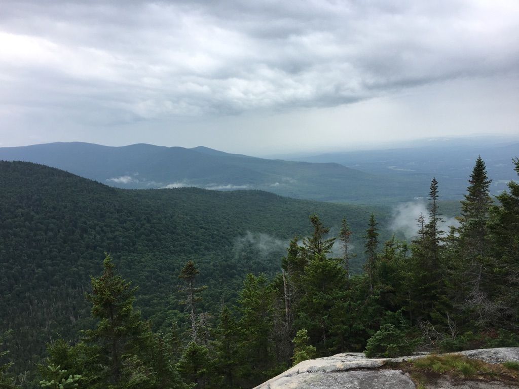Overcast view of rolling green mountains with mist in valleys. - Mount Cabot via Bunnell Notch Trail