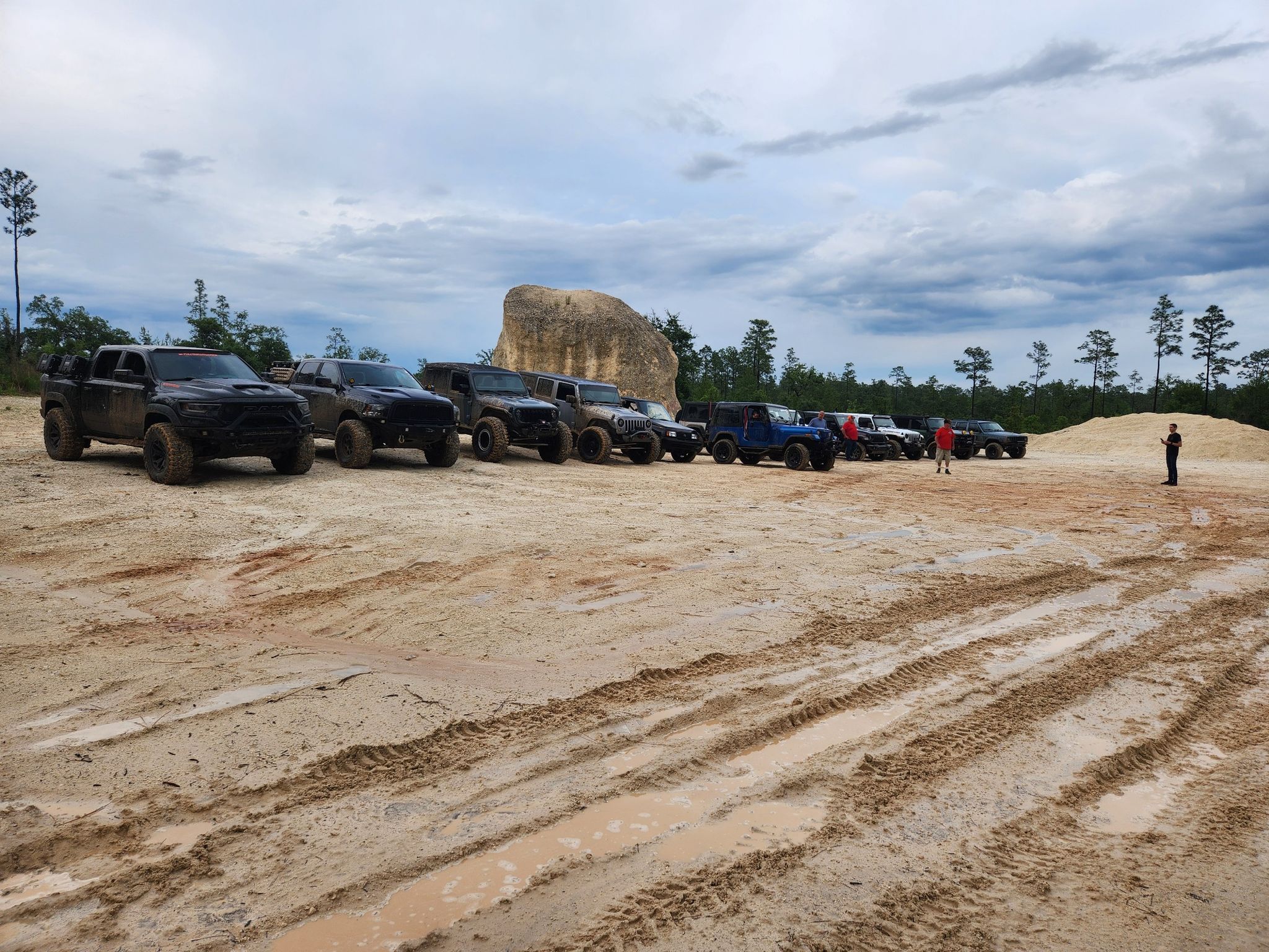 Off-road vehicles parked on sandy terrain under an overcast sky, one person standing. - Citrus Wildlife Management Area gravel loop from Sugarmill Woods
