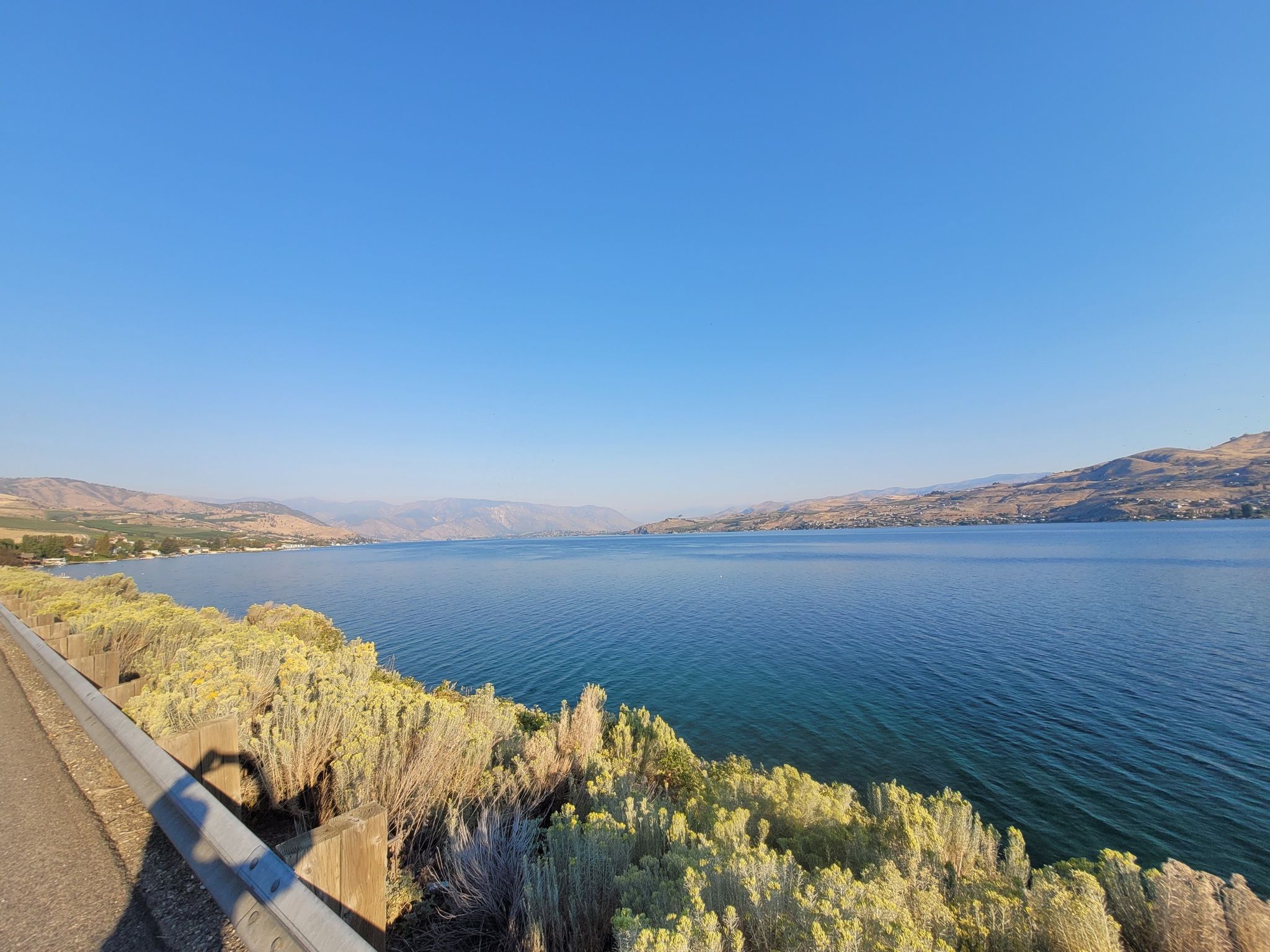Expansive lake with distant hills under a clear blue sky, bright daylight. - Don Morse Memorial Park – Lake Chelan State Park loop from Chelan
