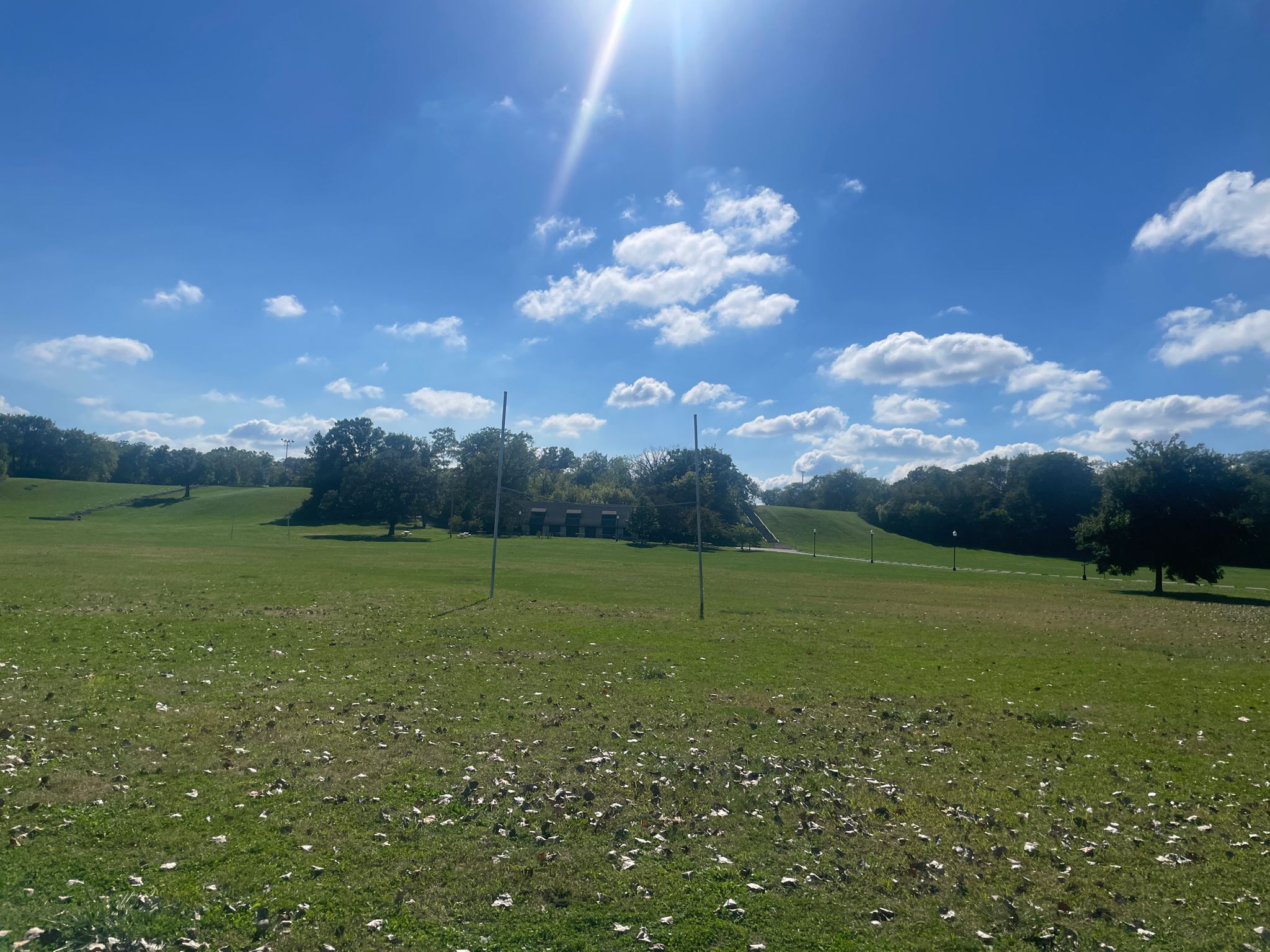 Bright sunny day over a wide green field with rolling hills. - Major Taylor Trail