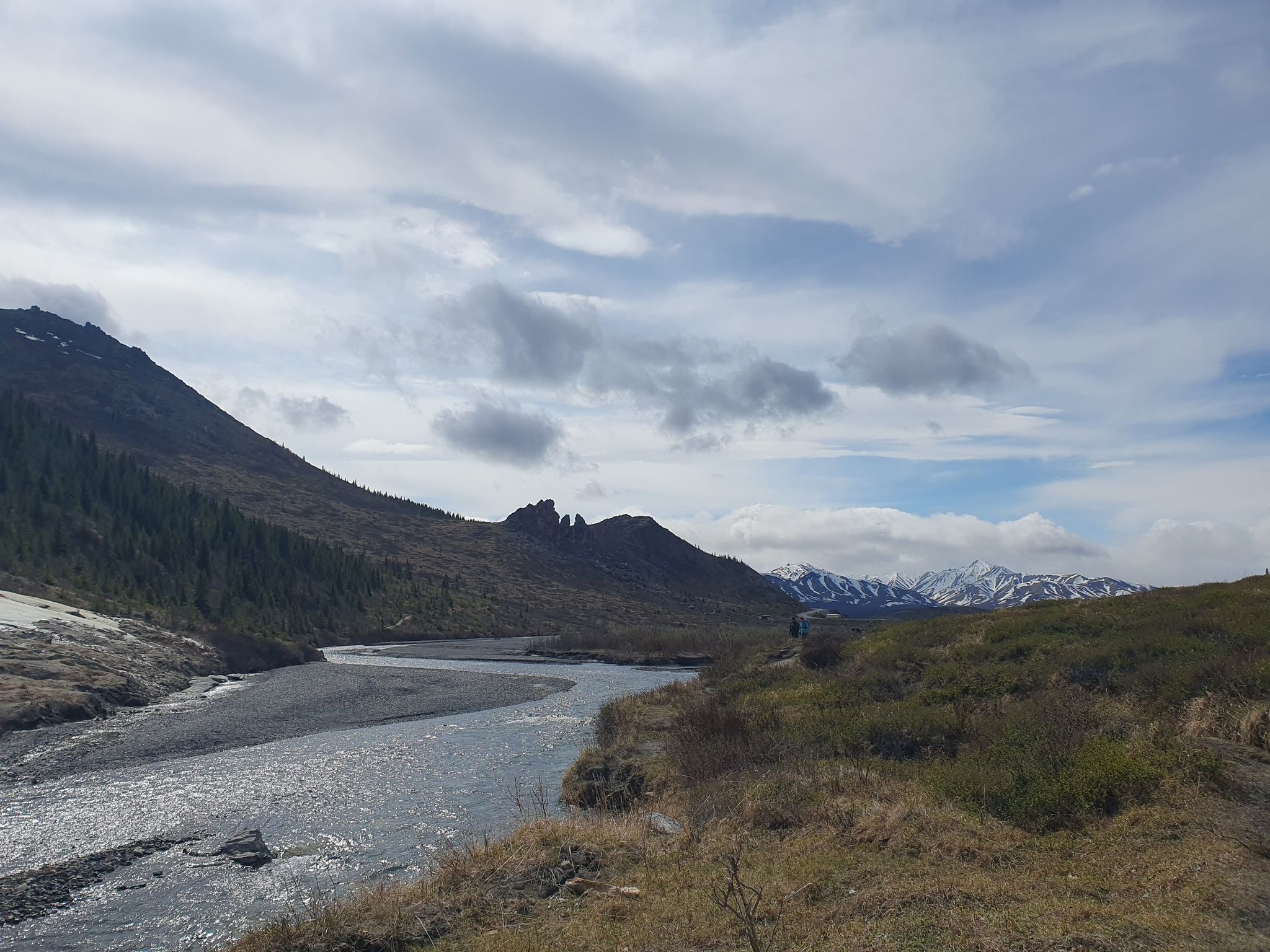 River in a valley with mountains, some snow, and cloudy sky. - Savage River Loop Trail