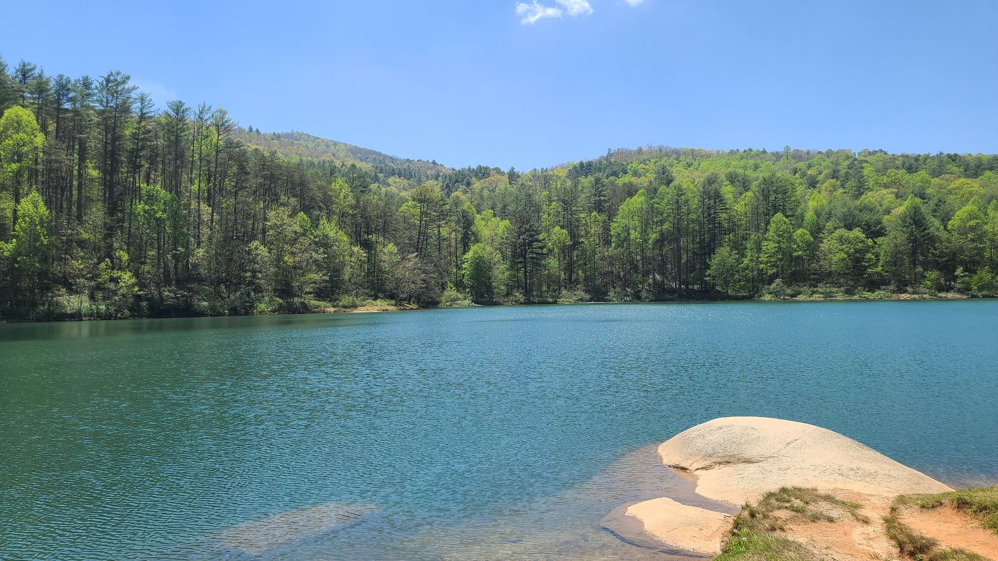 Bright blue lake surrounded by lush green forested mountains on a sunny day. - Edmonds Trail (West Fork)