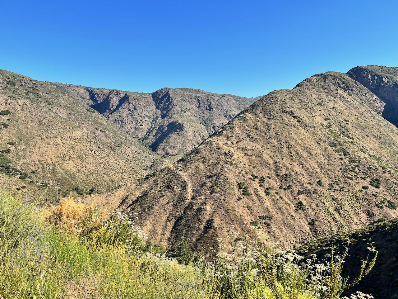 Arid mountains and valleys under a clear blue sky. - Cedar Creek Falls via Eagle Peak Road