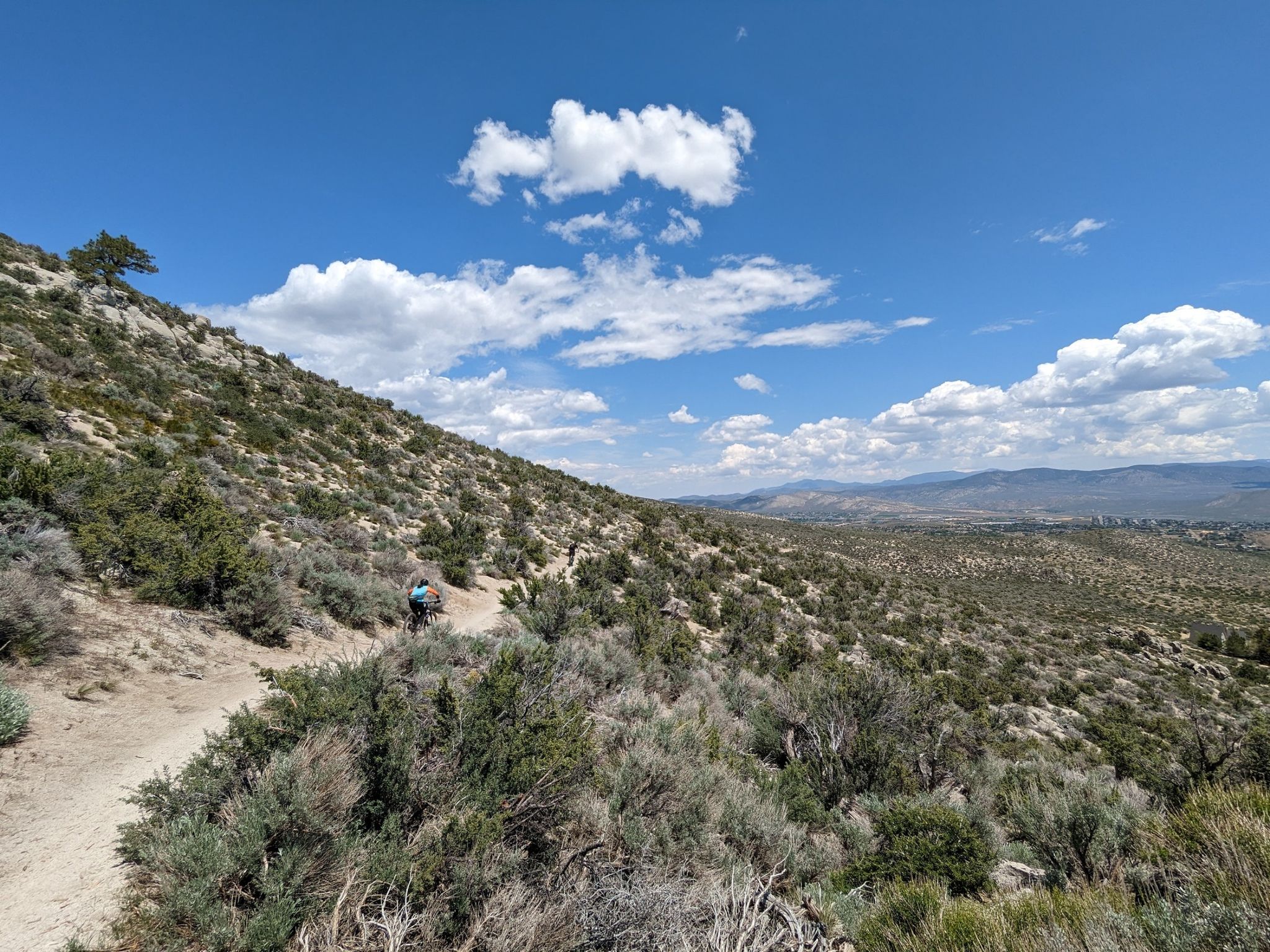 Hiker on a winding dirt trail on a sunny, arid hillside. - Genoa – Nevada State Railroad Museum loop from Carson & Mills Park Railroad