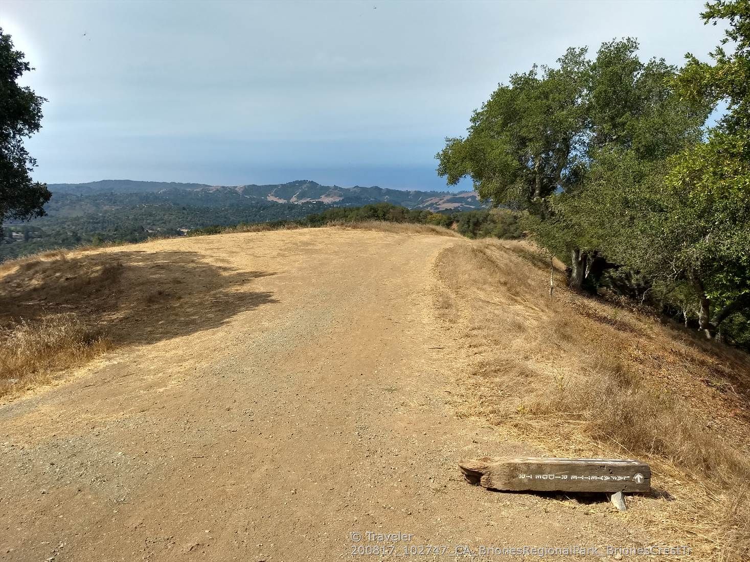 Dirt path on a hill with a wooden bench, overlooking distant landscape. - Lafayette Ridge and Russell Peak Loop