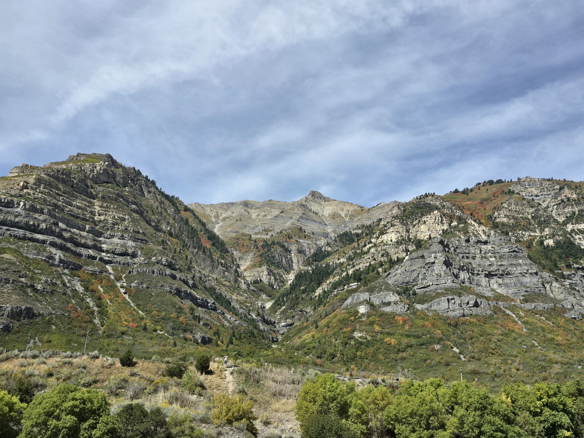 Wide view of rugged, rocky mountains with green and sparse vegetation. - Provo River Parkway