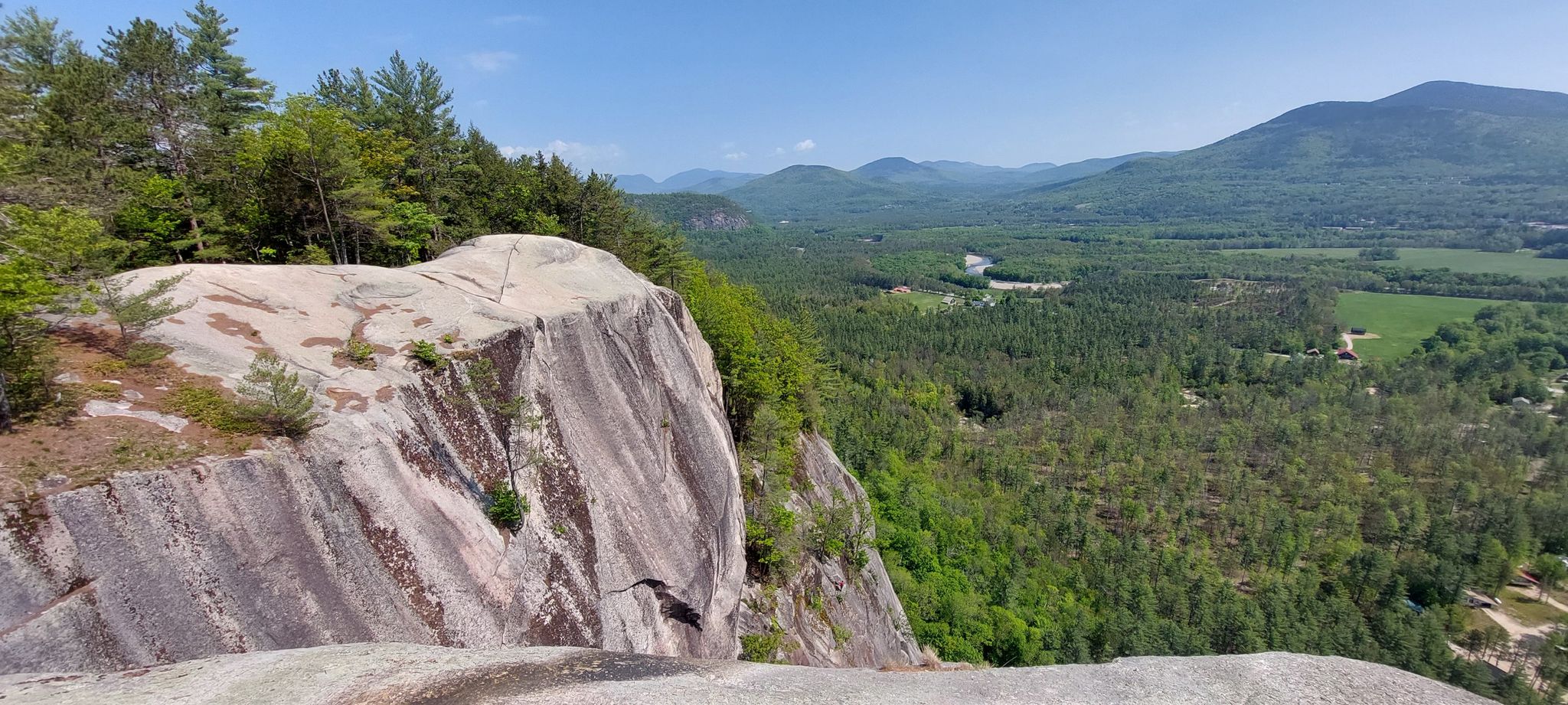 Expansive sunny view from a large rock cliff over a green forest valley. - Echo Lake, Cathedral Ledge, Whitehorse Ledge, and Diana's Baths