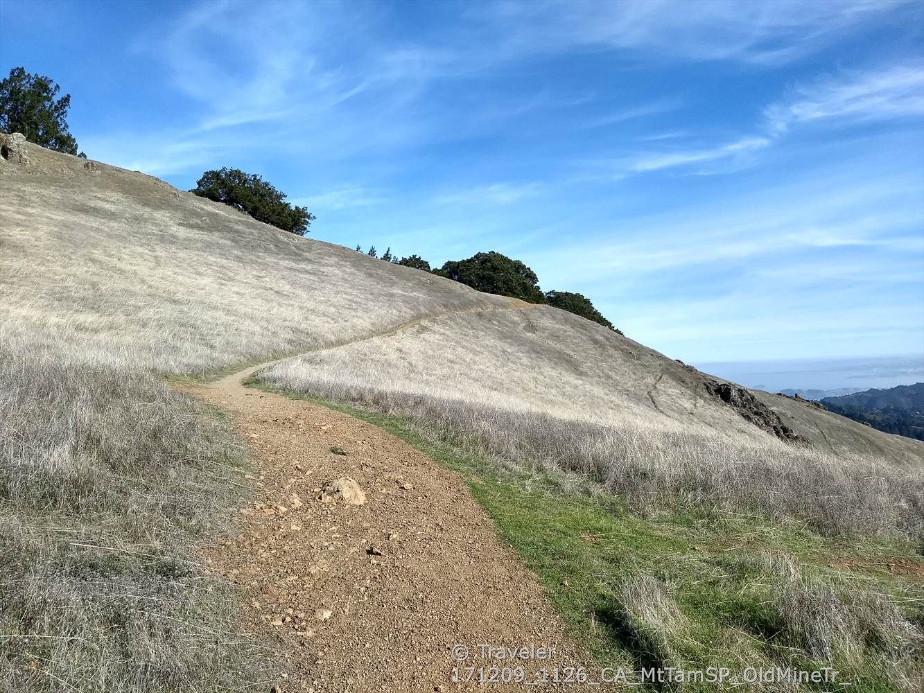 Dirt path winds up a dry grassy hill under a bright blue sky. - Matt Davis Trail and Rock Spring Trail Loop