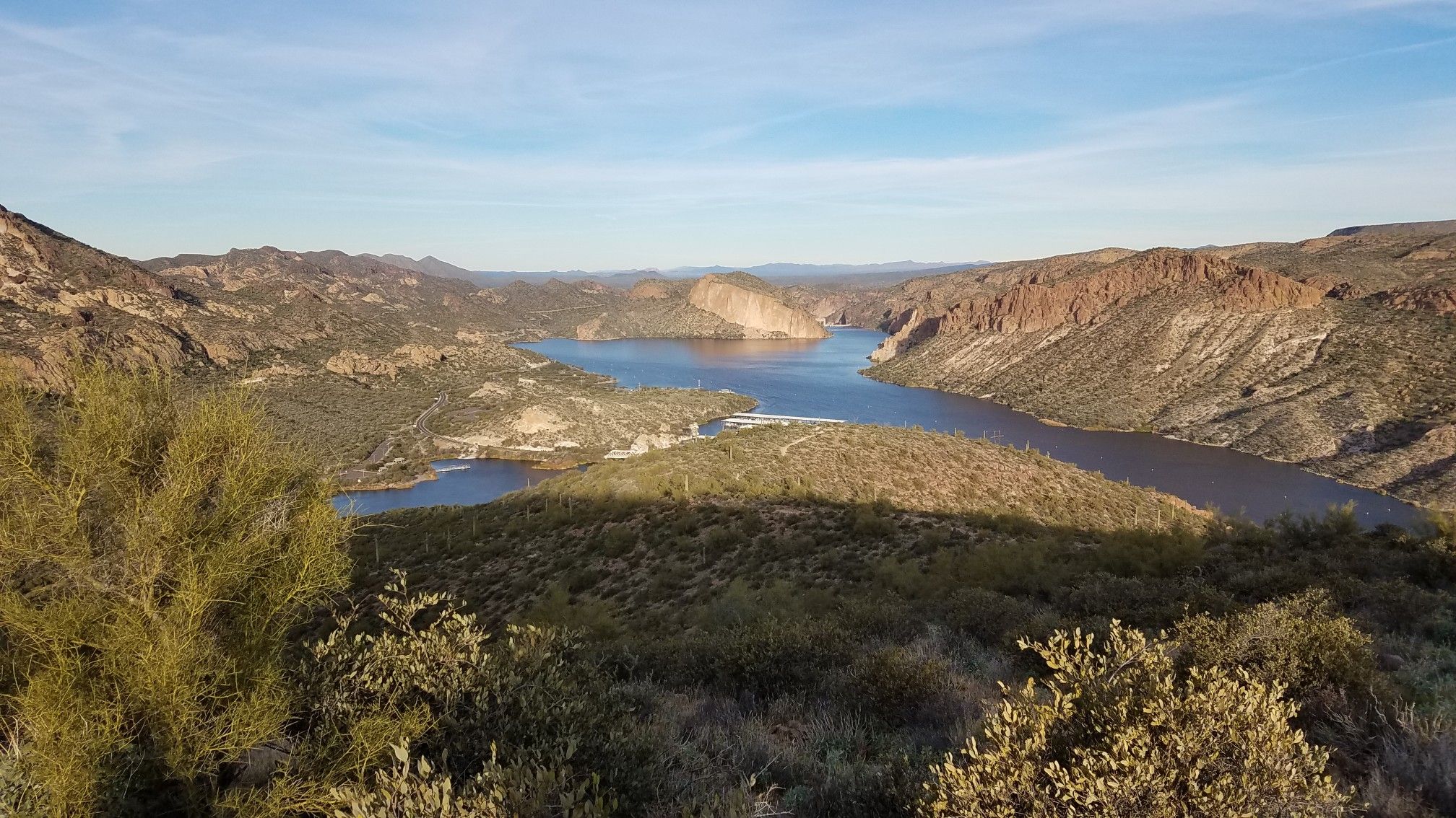 Wide lake winding through arid mountains under a clear blue sky. - Battleship Mountain and Boulder Canyon Trail Loop
