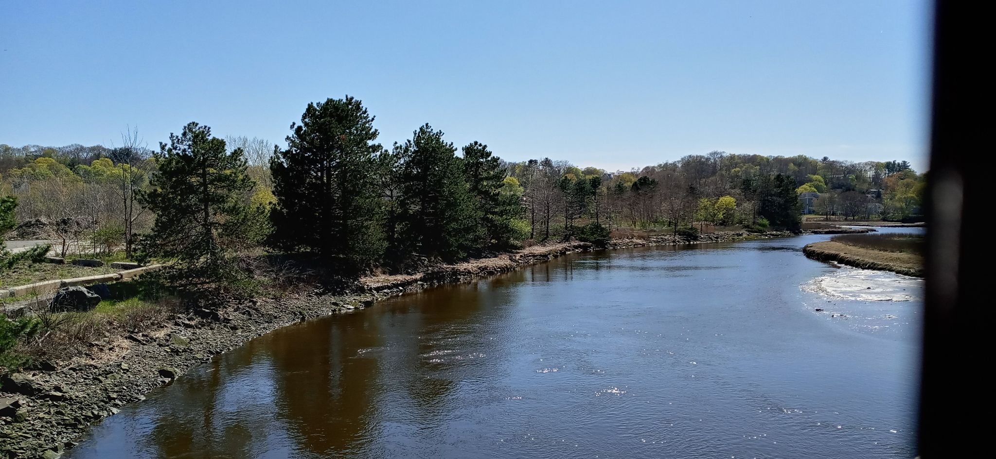 River flowing past a treelined bank under a bright blue sky. - Saugus River Reservation – Ell Pond loop from Melrose Highlands