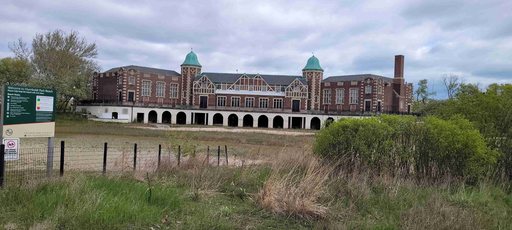 Large, ornate brick building with green domes under an overcast sky. - Humboldt Park Lagoon – Garfield Park loop from Kedzie