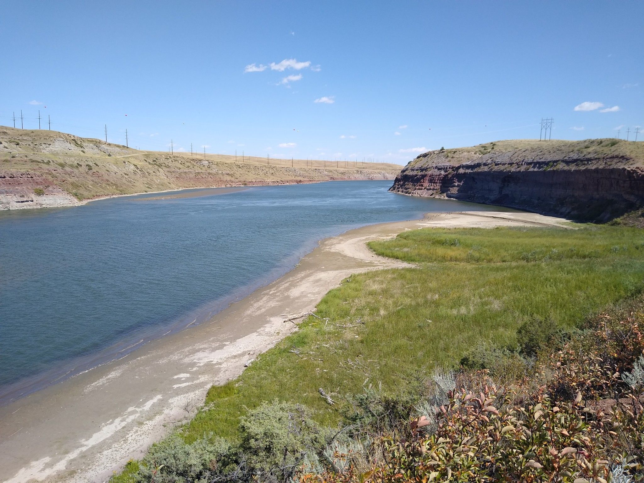 Wide river flowing between arid hills under a clear blue sky. - River's Edge Trail: South Shore