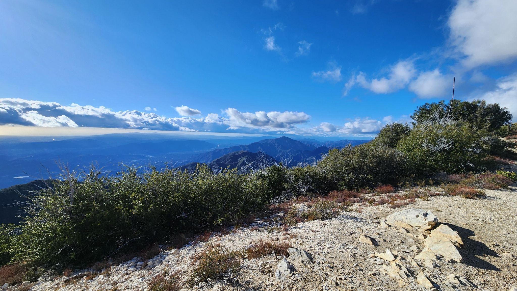 Mountain vista under a bright blue sky with scattered clouds. - Mount Lowe Summit – Inspiration Point loop from Altadena