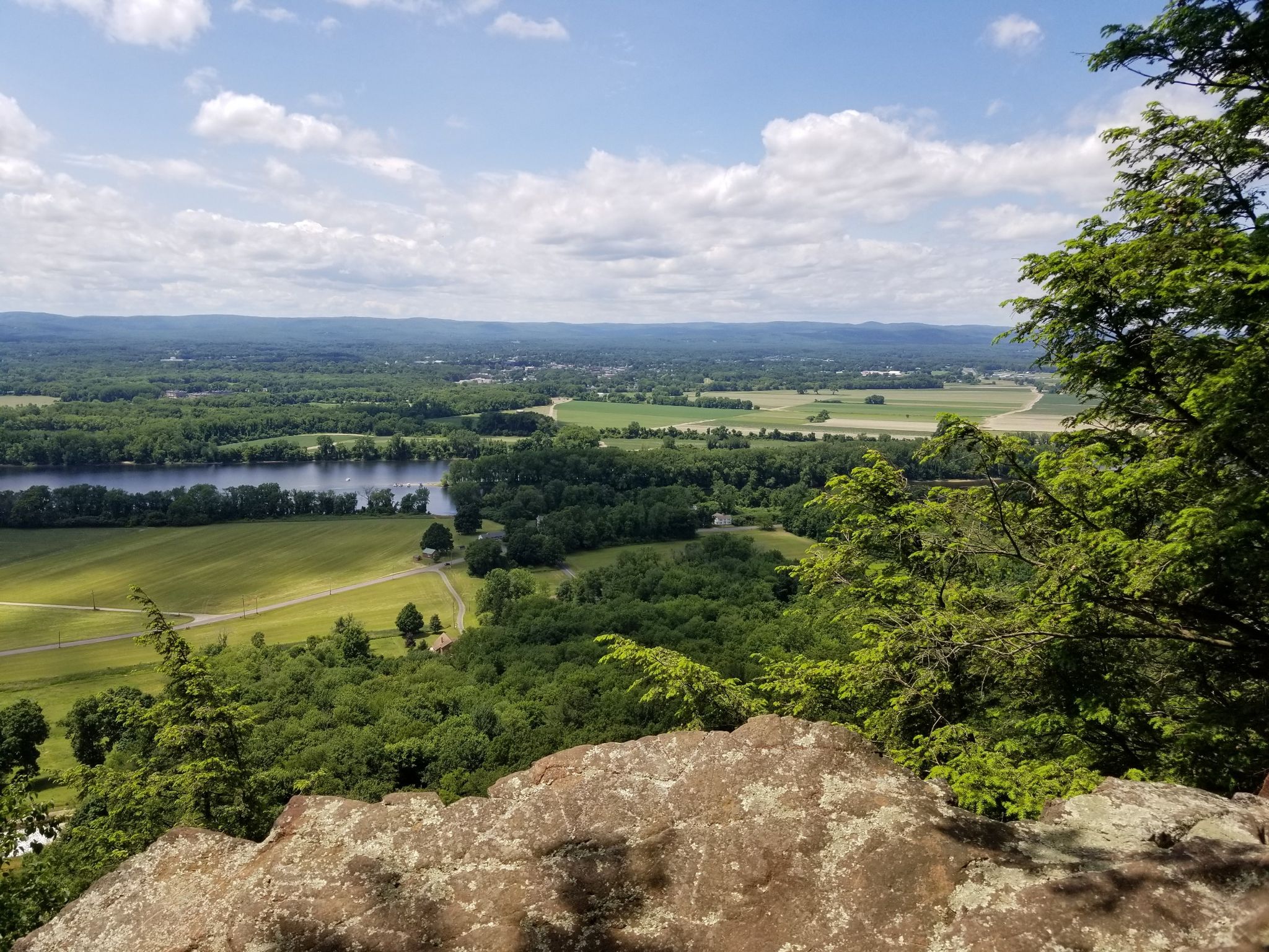 Sunny overlook of a river, green fields, and distant hills. - Dry Brook – Lithia Springs – Black Rock – New England Trail Loop – Joseph Allen State Forest