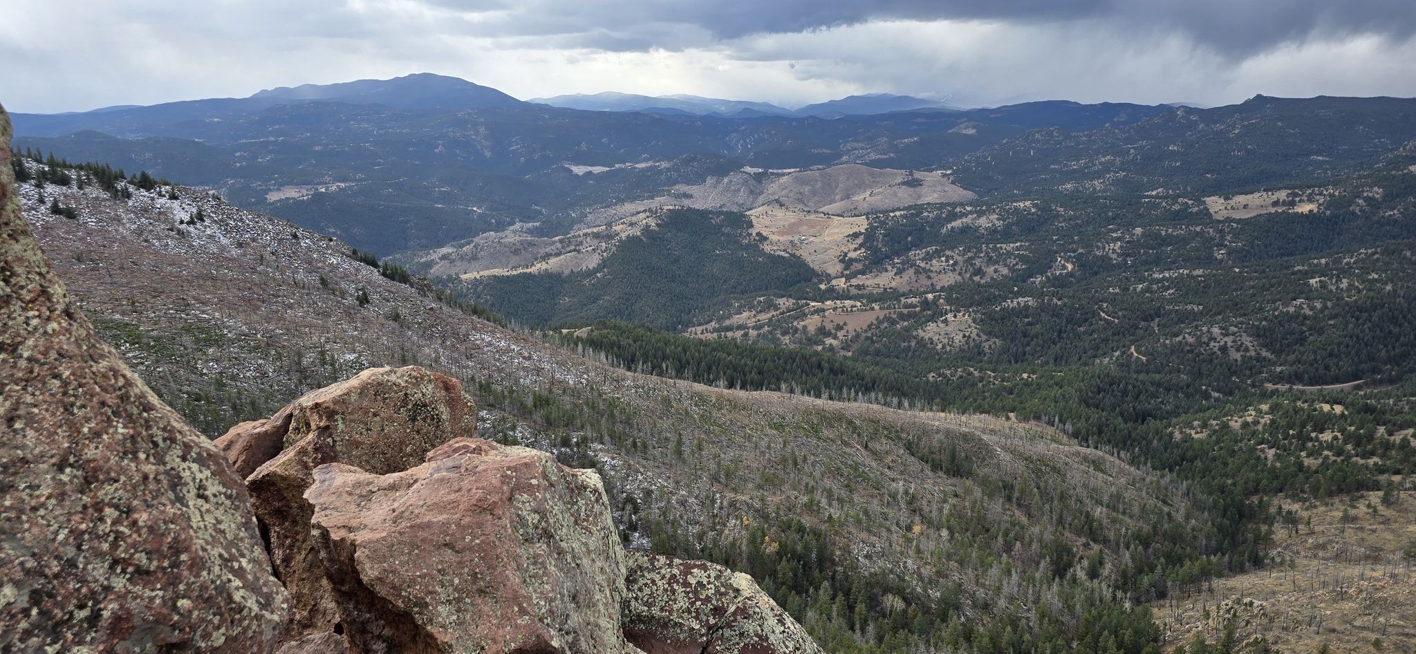A panoramic view of mountains and valleys with rocky foreground under cloudy sky. - Bear Creek – Bear Peak loop from National Center for Atmospheric Research