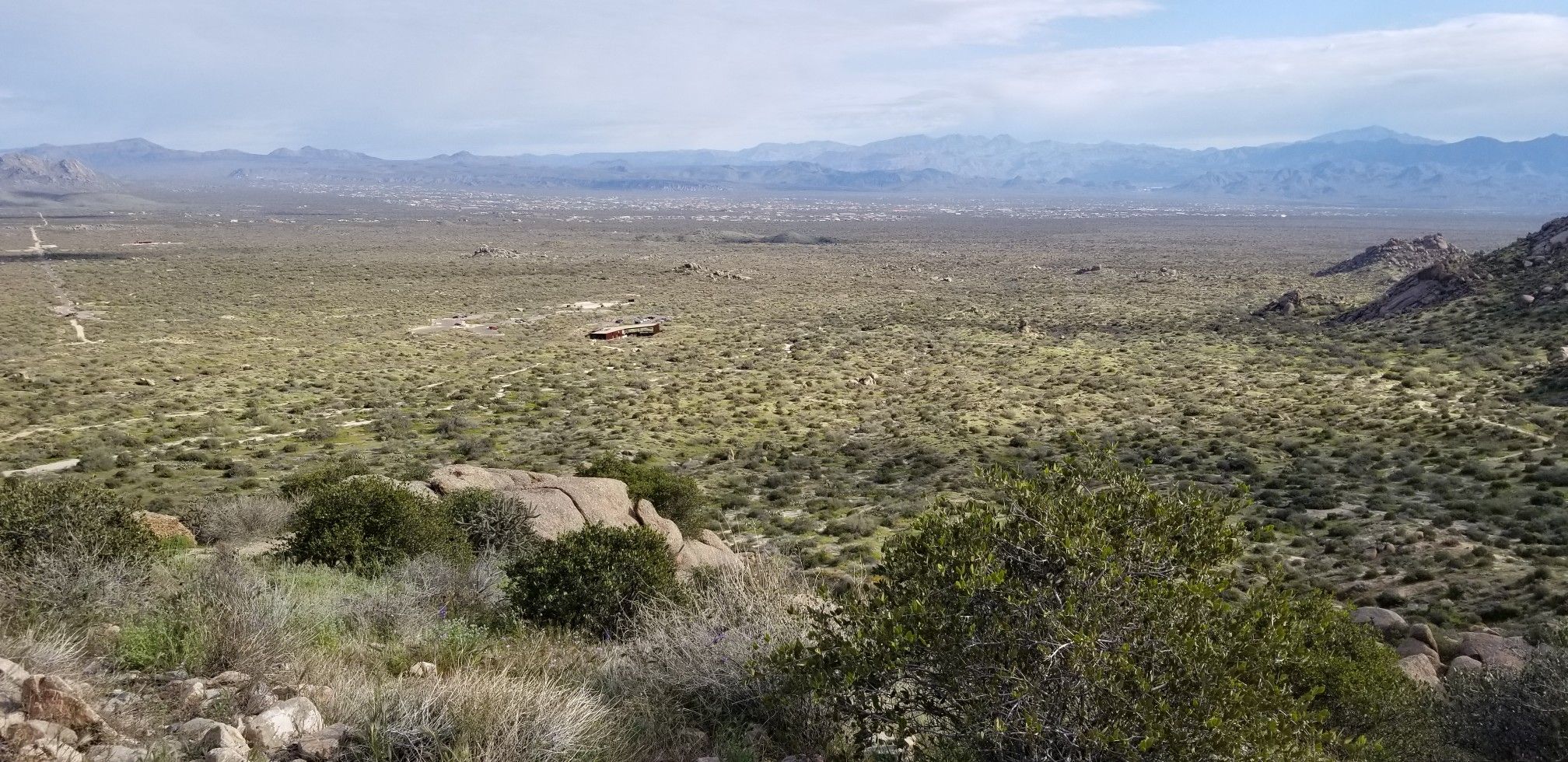Vast desert landscape with distant mountains under a partly cloudy sky. - McDowell Mountain Rim to Rim