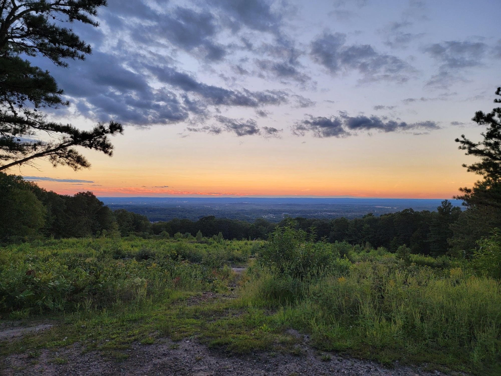 Vast landscape at sunset with colorful sky over distant hills and trees. - Lookout Mountain – Birch Mountain loop from Salster Open Space