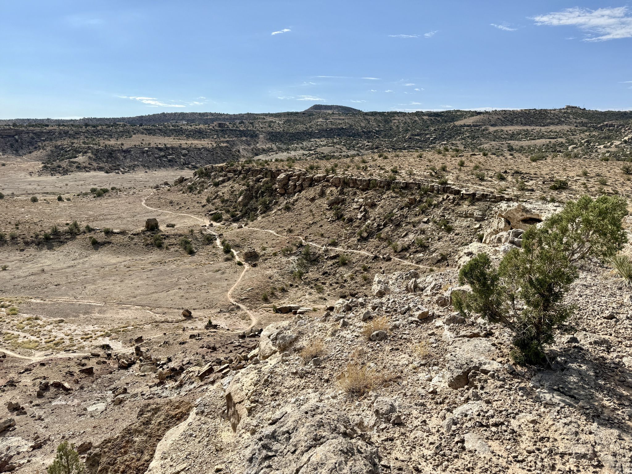 Sunny desert landscape with a winding dirt trail through rocky terrain. - Holy Bucket Trail via Miramonte Rim and Tabeguch loop