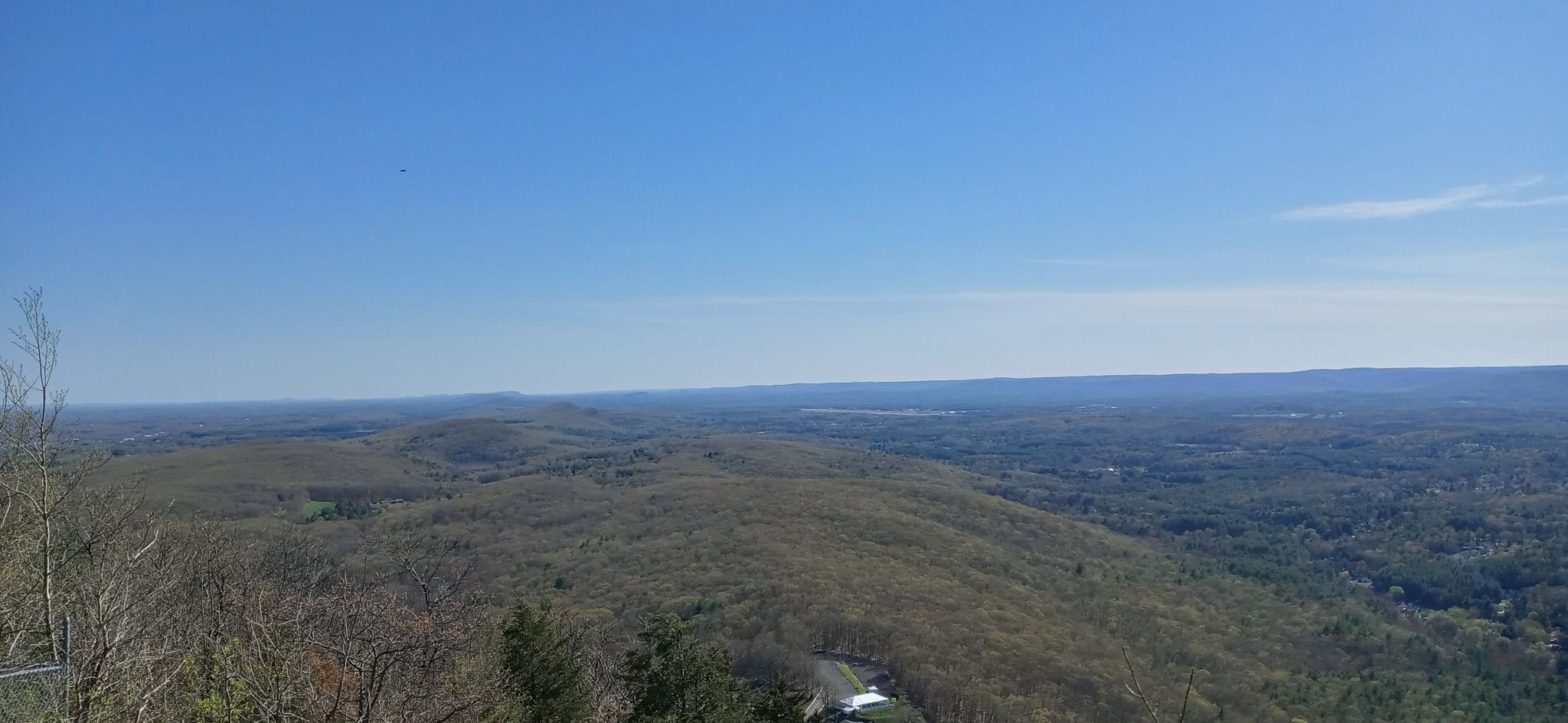 Vast forested hills under a clear blue sky on a sunny day. - NET/M&M Trail (white)