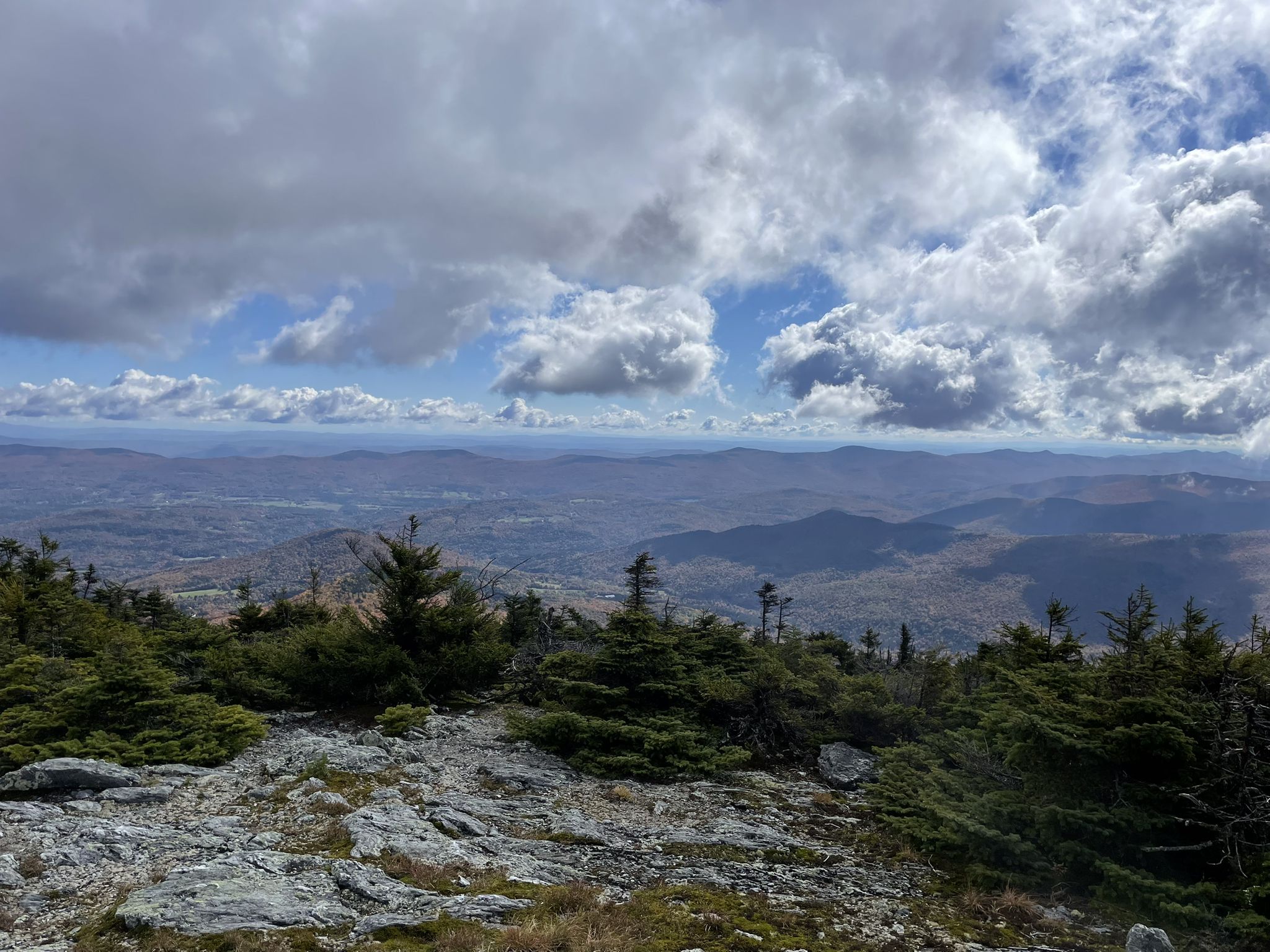 Panoramic view of rolling mountains under a partly cloudy sky with rocky foreground. - Long Trail: Appalachian Gap to Lincoln Gap