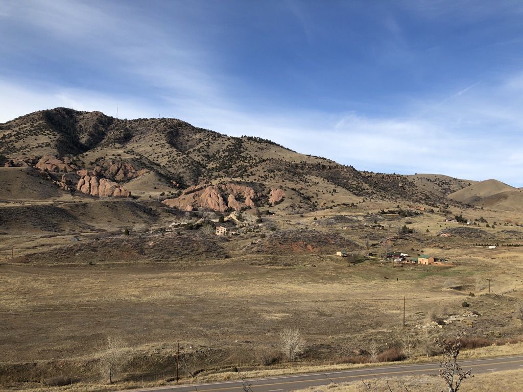 Expansive view of dry, rolling hills and plains under a clear blue sky. - Dakota Ridge and Red Rocks Trail