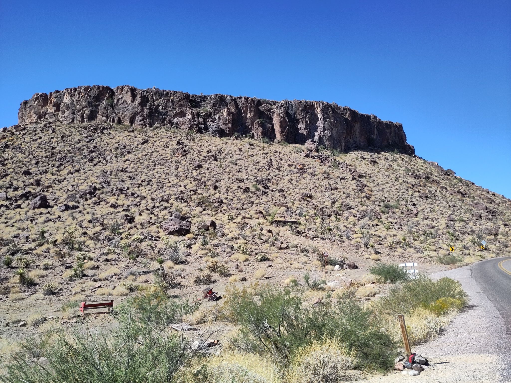 Desert hill with a flat-topped mesa under a clear blue sky. - Kingman to Oatman via Route 66
