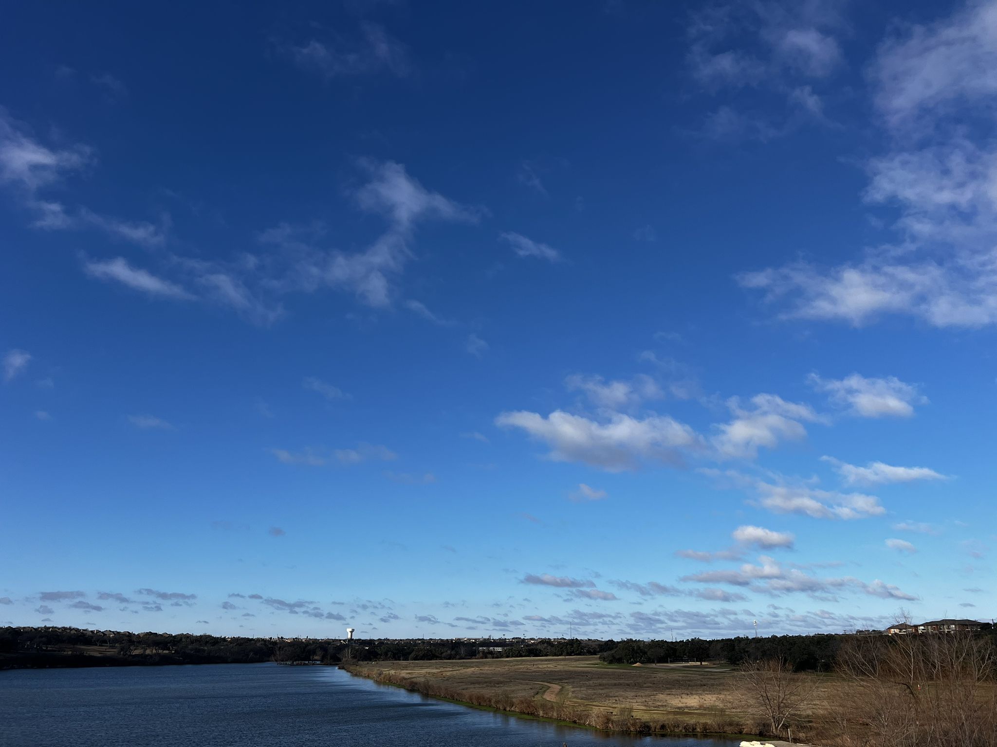 Vast blue sky over a wide body of water and distant flat land. - Round Rock to Brushy Creek Hike and Bike Trail loop