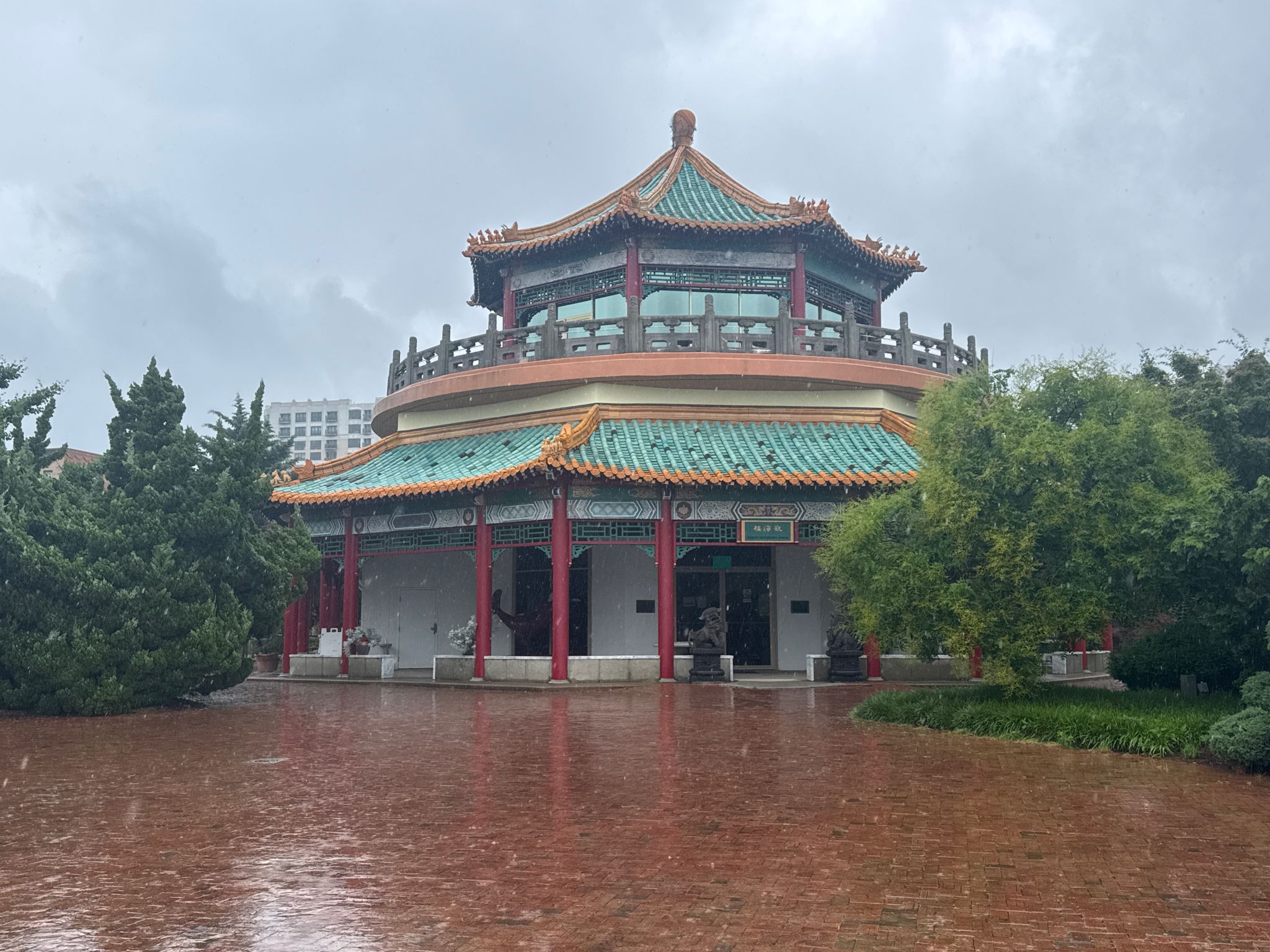 Ornate Asian-style pavilion with green roofs on a rainy, overcast day. - Chrysler Museum of Art loop from MacArthur Square