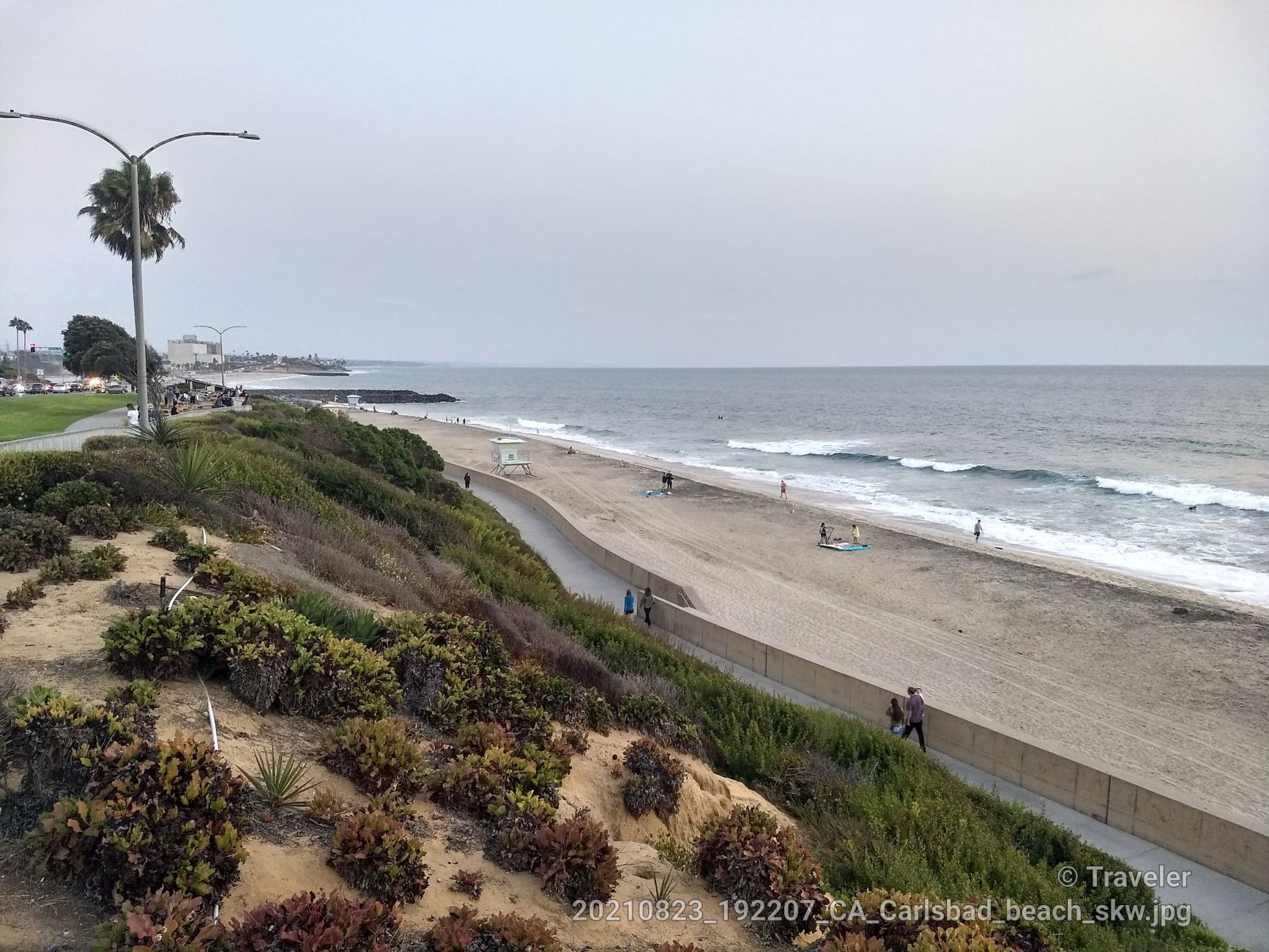 Overcast view of a beach, ocean, coastal path, and green hillside. - Tamarack Beach – Tamarack Beach loop from Carlsbad