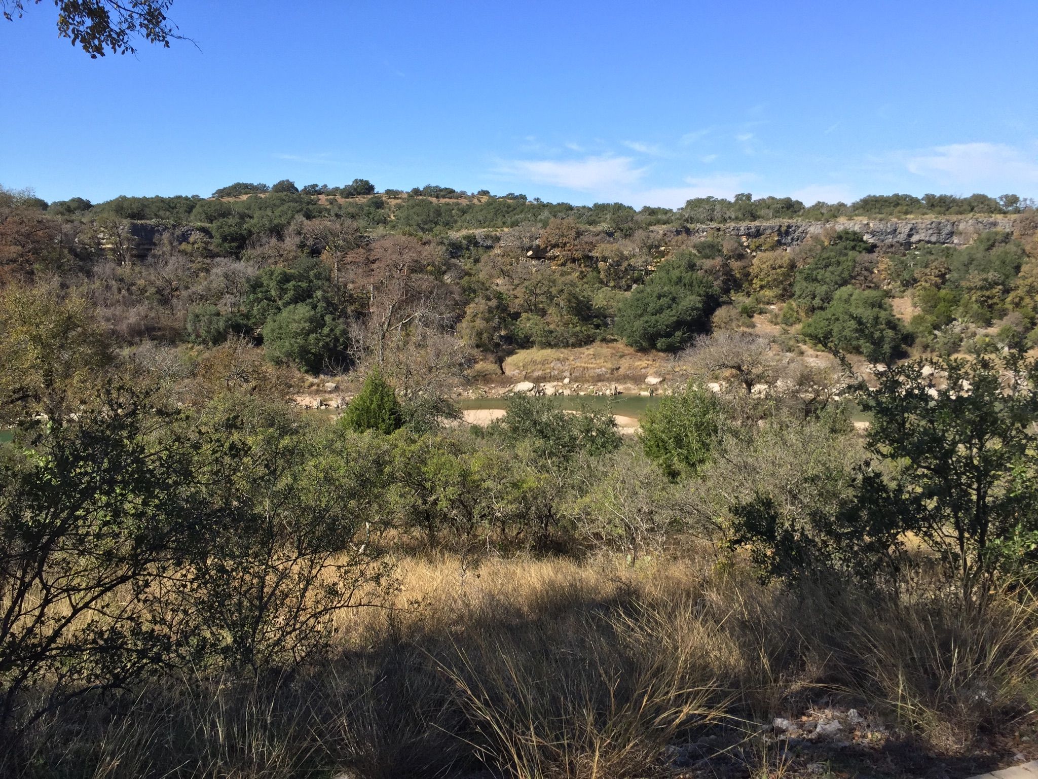 Sunny wide view of a river in a valley with trees and rocky cliffs. - Milton Reimers Ranch Park – Gnarled tree loop from Milton Reimers Ranch Park