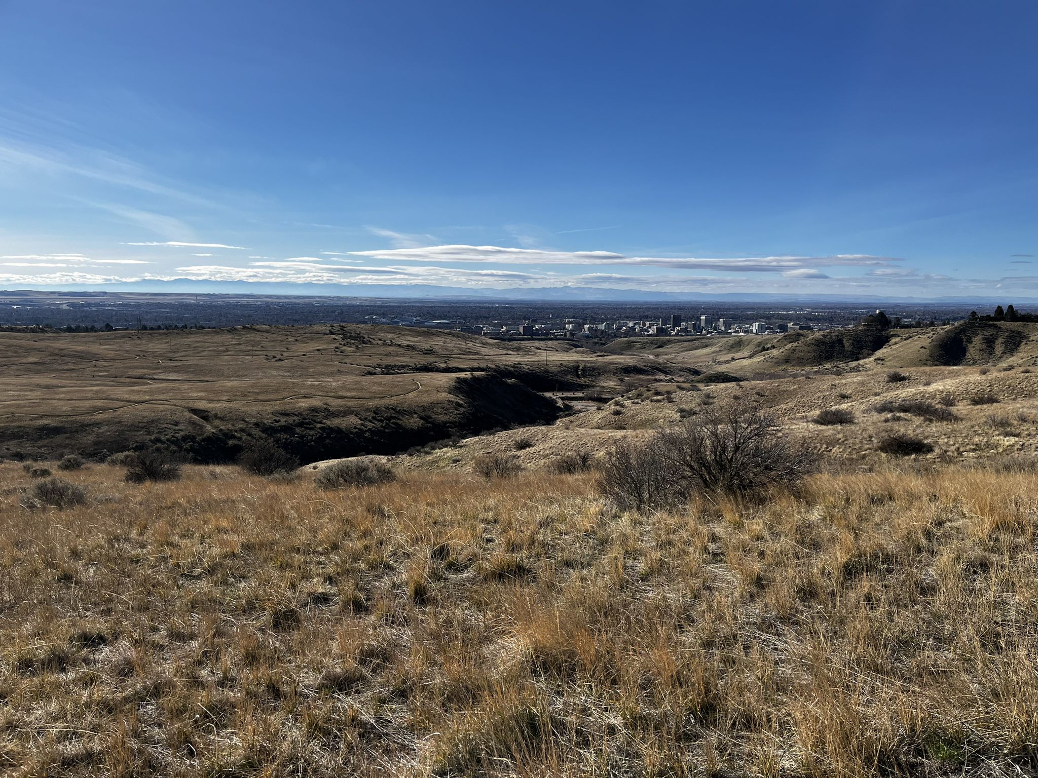 Wide view of dry, grassy fields and a ravine, with a distant city. - Freestone Ridge, Femrite's Patrol, and Three Bears Loop