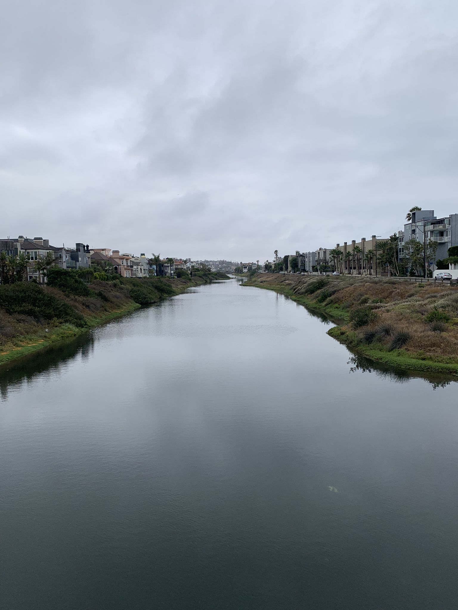 Overcast view of a calm river flowing between residential buildings. - Venice Beach Bike Path – Venice Beach Boardwalk loop from Downtown Santa Monica