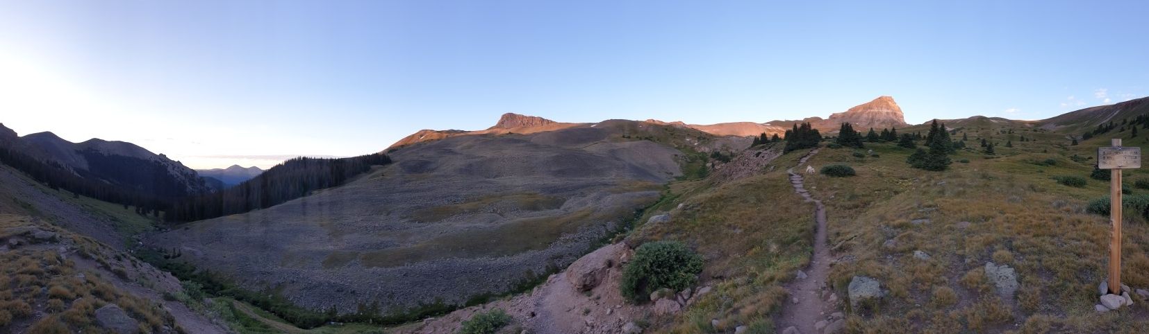 Panoramic view of a mountain valley with a trail and golden light. - Uncompahgre Peak Trail