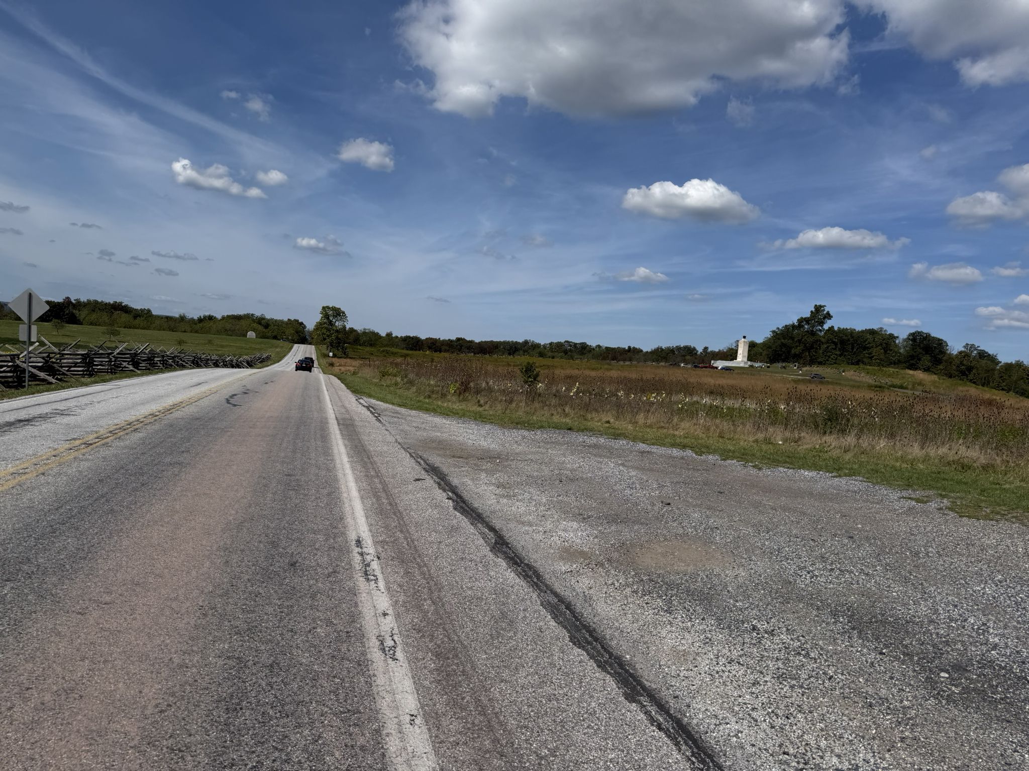 Long paved road through open fields under a bright, cloudy blue sky. - 9-11 Trail (Pennsylvania Loop)