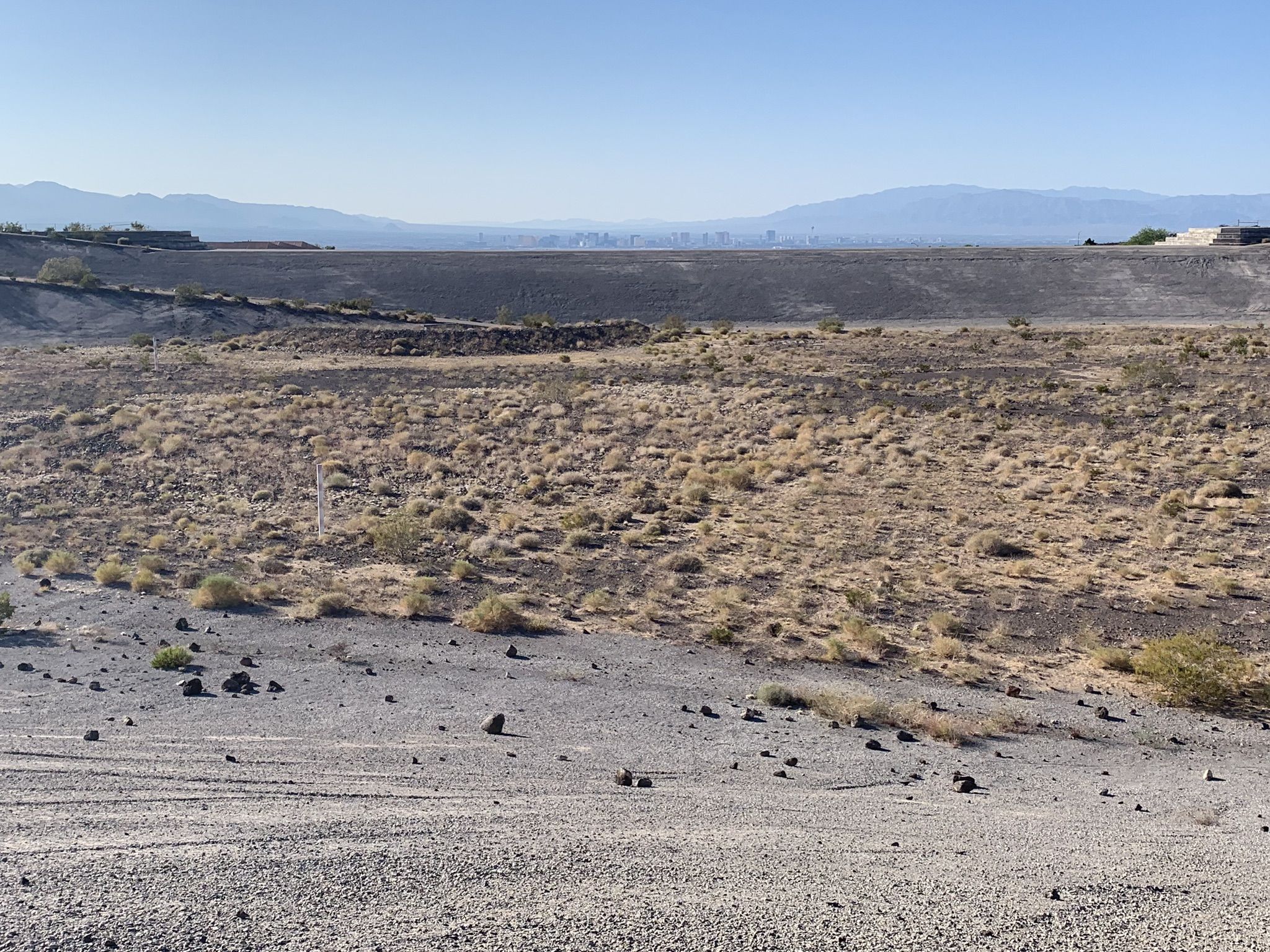 Dry desert landscape with sparse vegetation, rocky ground, and distant mountains. - Anthem East Trailhead – Black Mountain Trail loop from Silverado Ranch