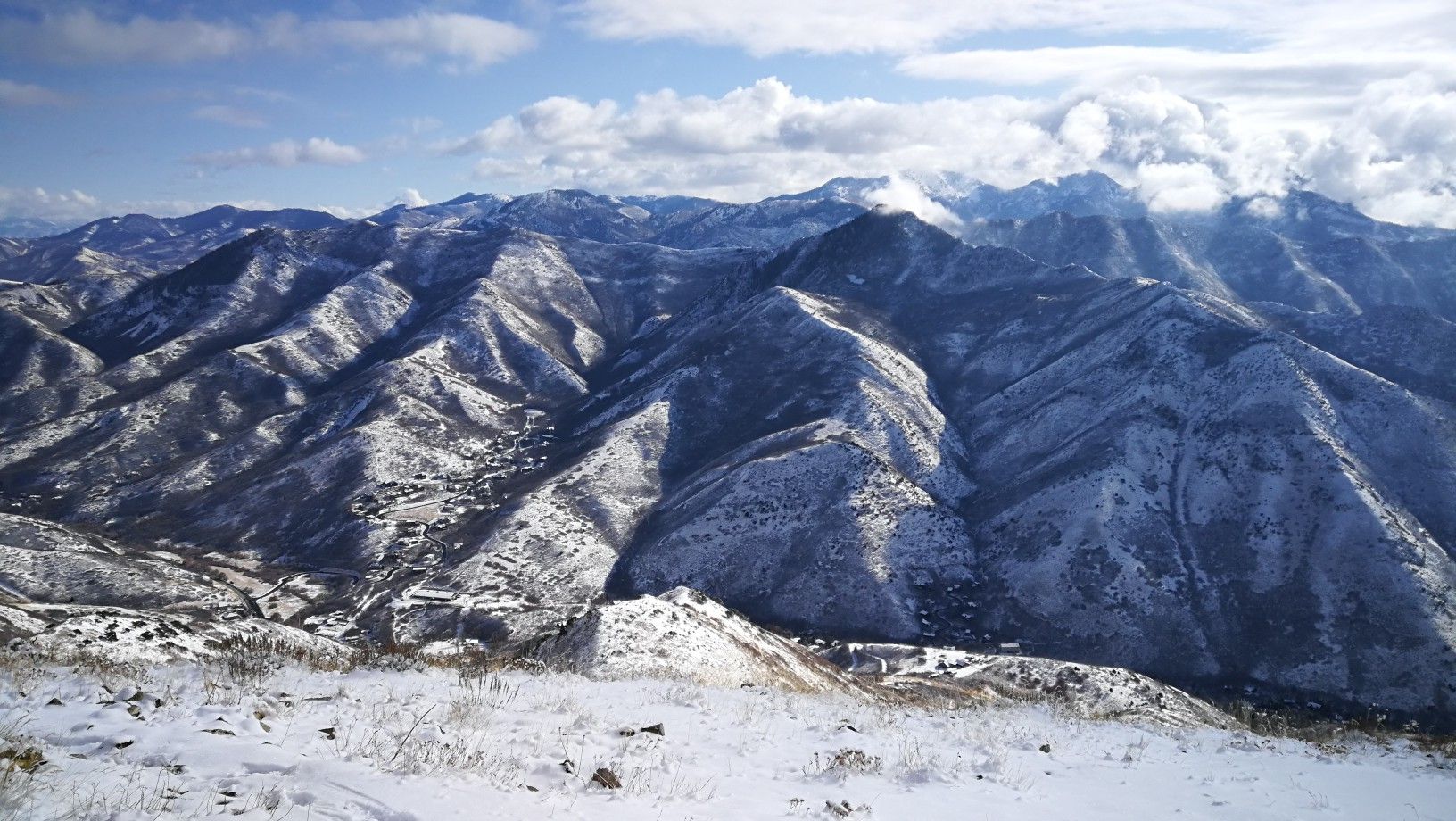 Majestic snow-covered mountains under a partly cloudy sky, winter landscape. - This Is the Place Monument – Mount Wire loop from This is the Place Monument