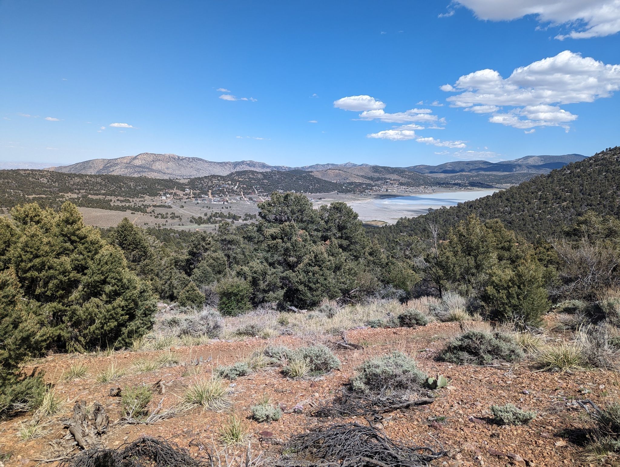 Expansive view of a valley with a lake, trees, and mountains under blue sky. - Gold Mountain and Pacific Crest Trail Loop