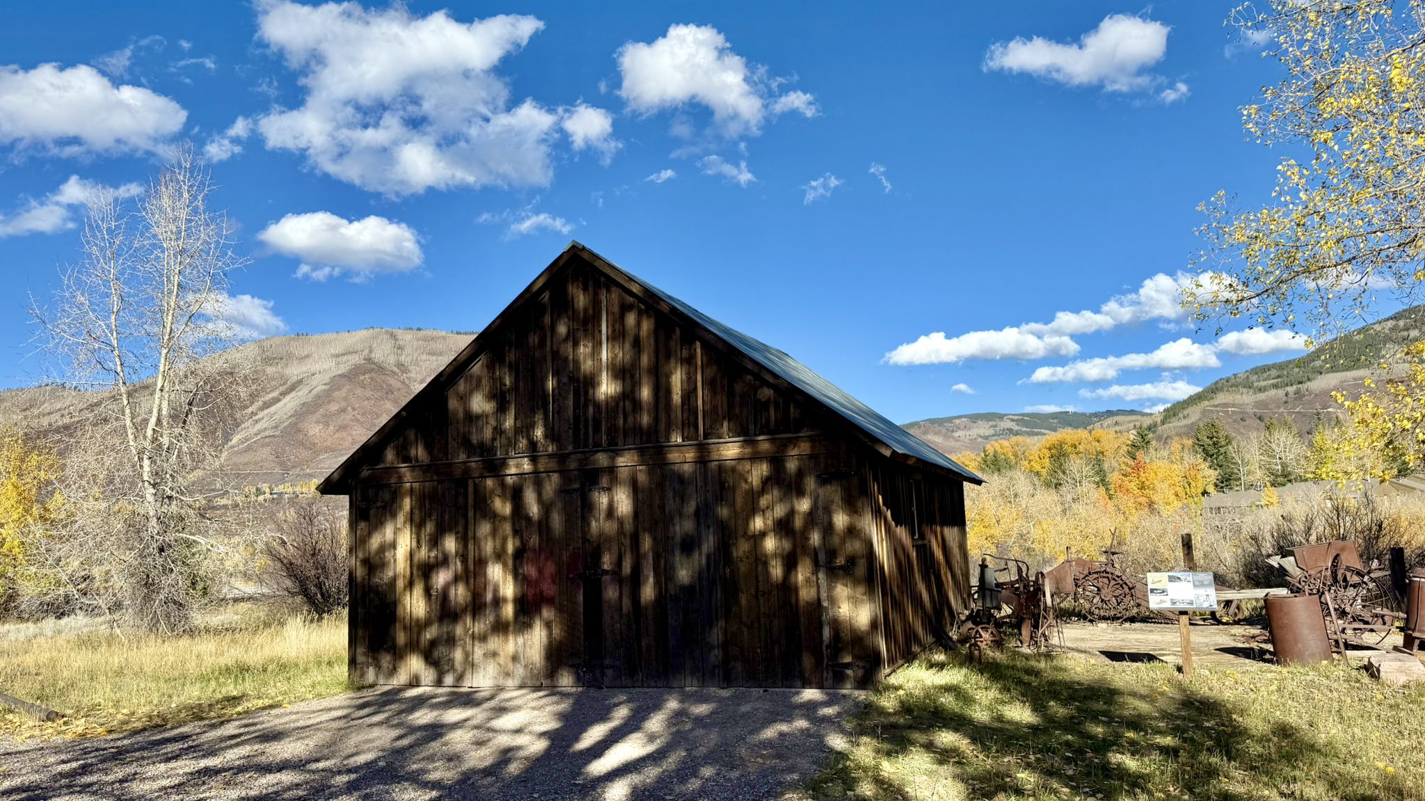 Old wooden barn with autumn trees and mountains under a blue sky. - Marolt Open Space – Moore Open Space loop from Aspen