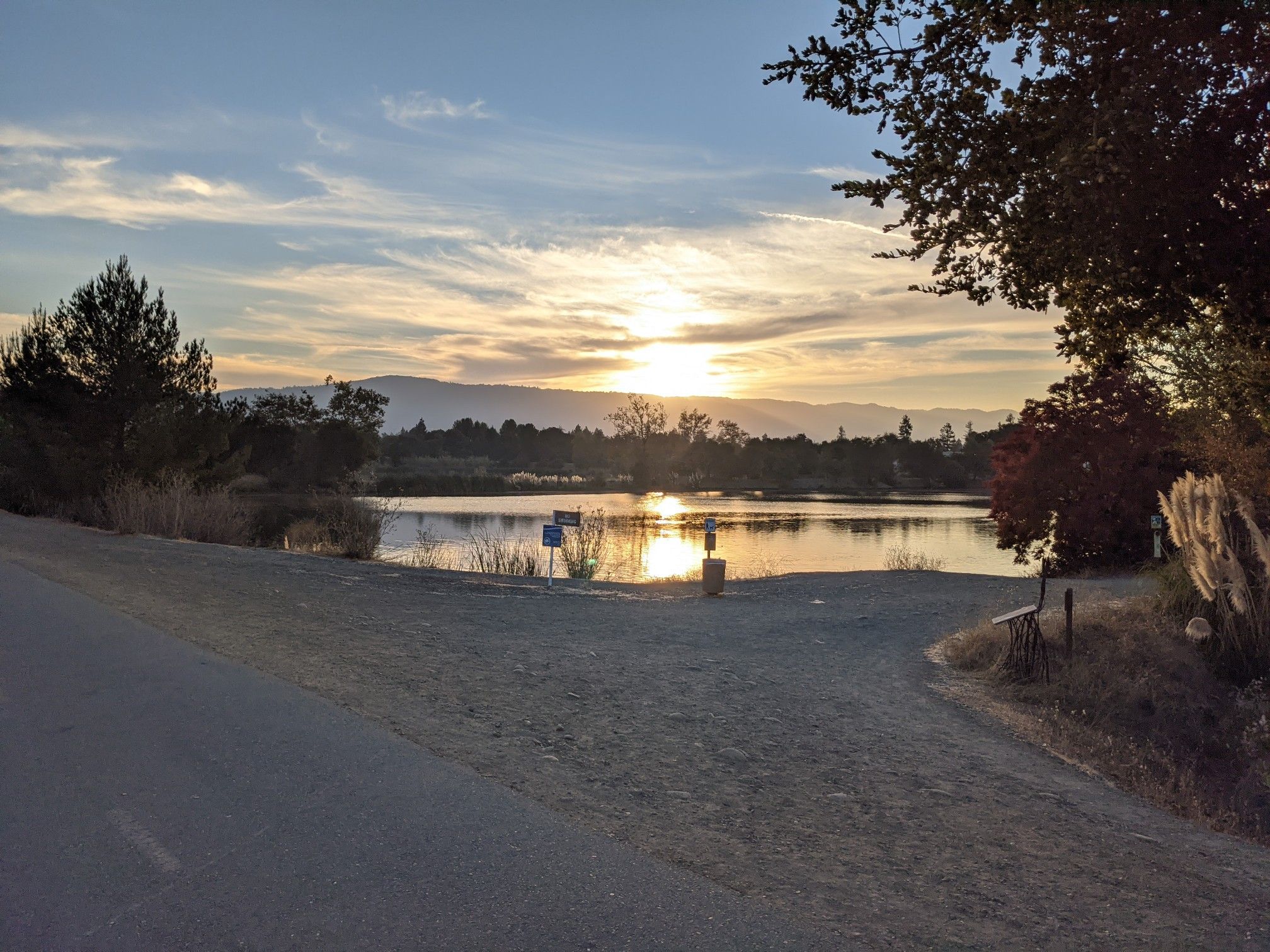 Sunset over a lake with mountains in the distance, warm light. - Camden Ponds – Fly Casting Pond loop from Cambrian Park