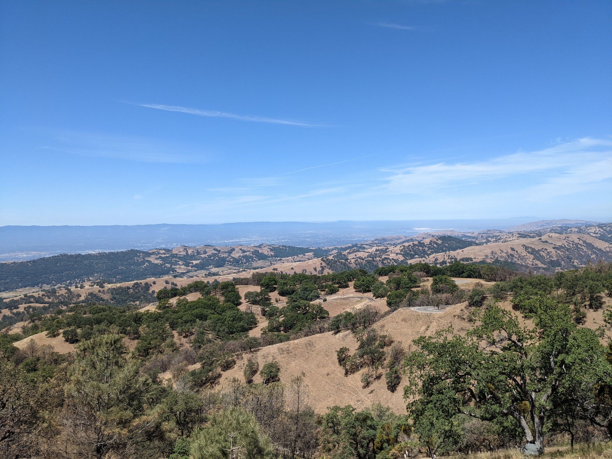 Wide vista of rolling dry hills with scattered trees under a blue sky. - Mount Hamilton Observatory 🔭📡 – Mount Hamilton Road loop from Joseph D. Grant County Park