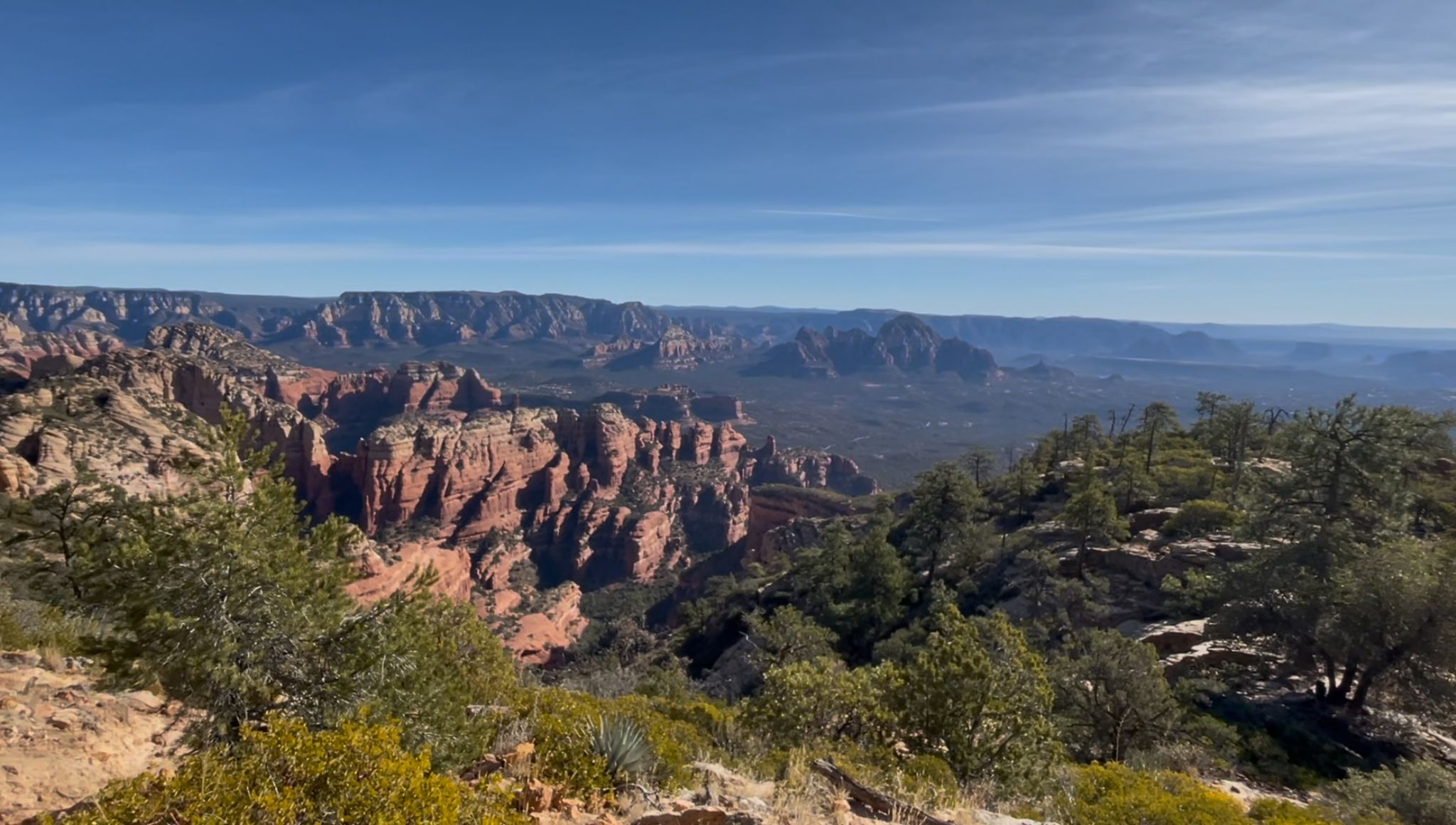 Expansive view of red rock canyons and green trees under a clear blue sky. - Dry Creek Road to Long Canyon Road & Aerie Road