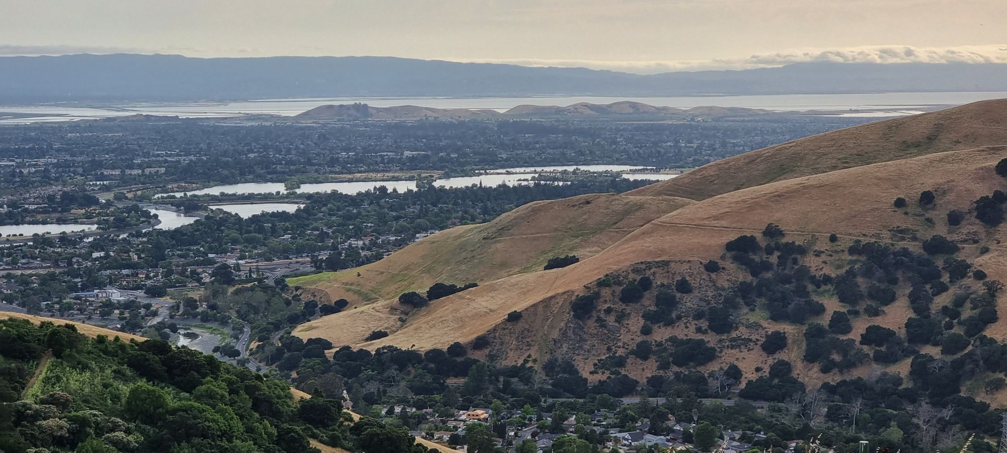 Panoramic view of dry hillsides overlooking a city with multiple lakes. - Golden Eagle and Upper Ranch Loop