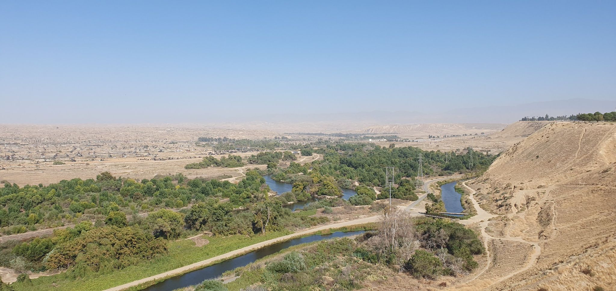 Canals winding through a green valley surrounded by dry, sunny hills. - Panorama Park loop from Garces High School