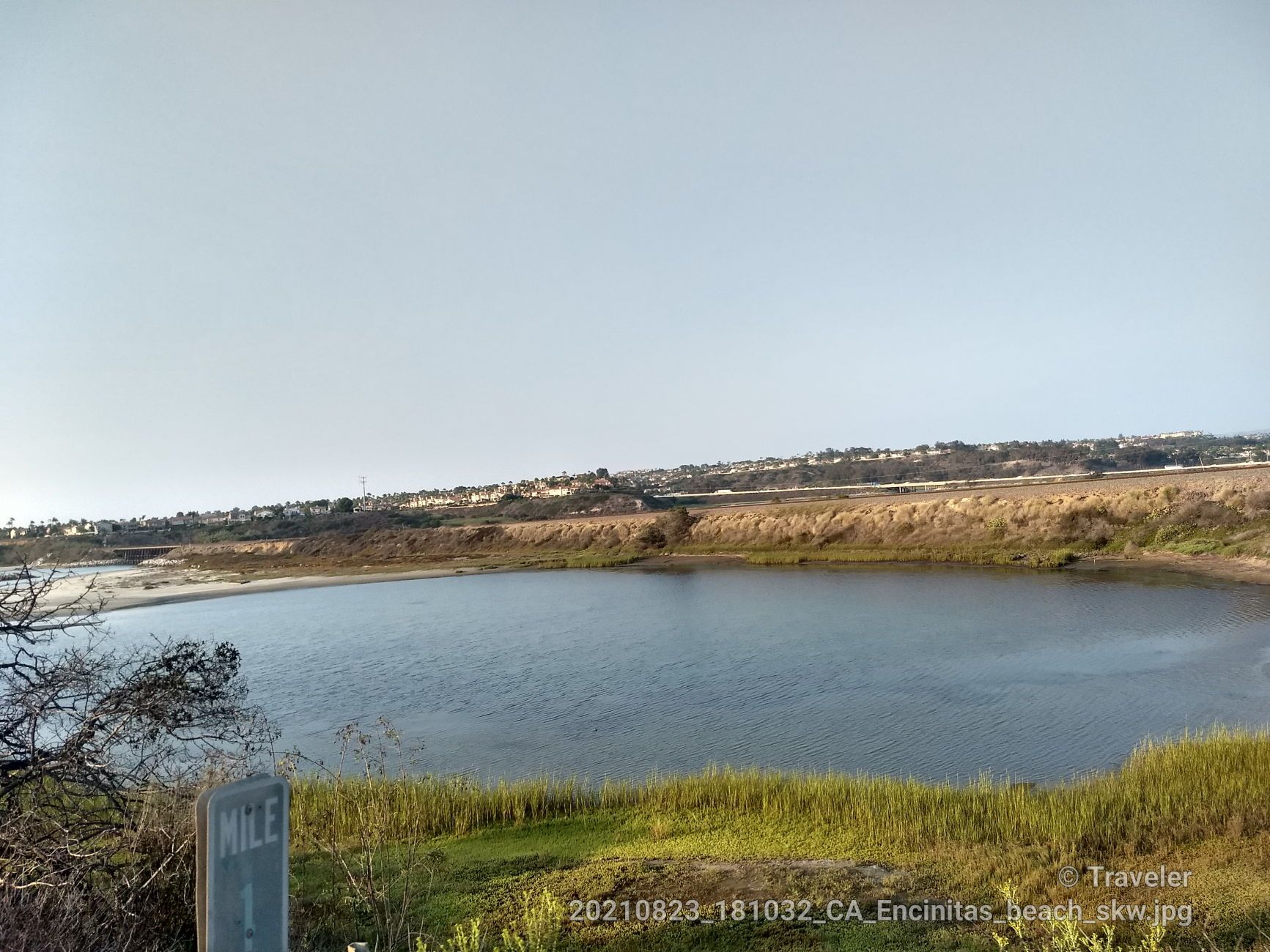 Calm body of water surrounded by green and brown vegetation. - Roadbike loop from Meadowlark Community Church