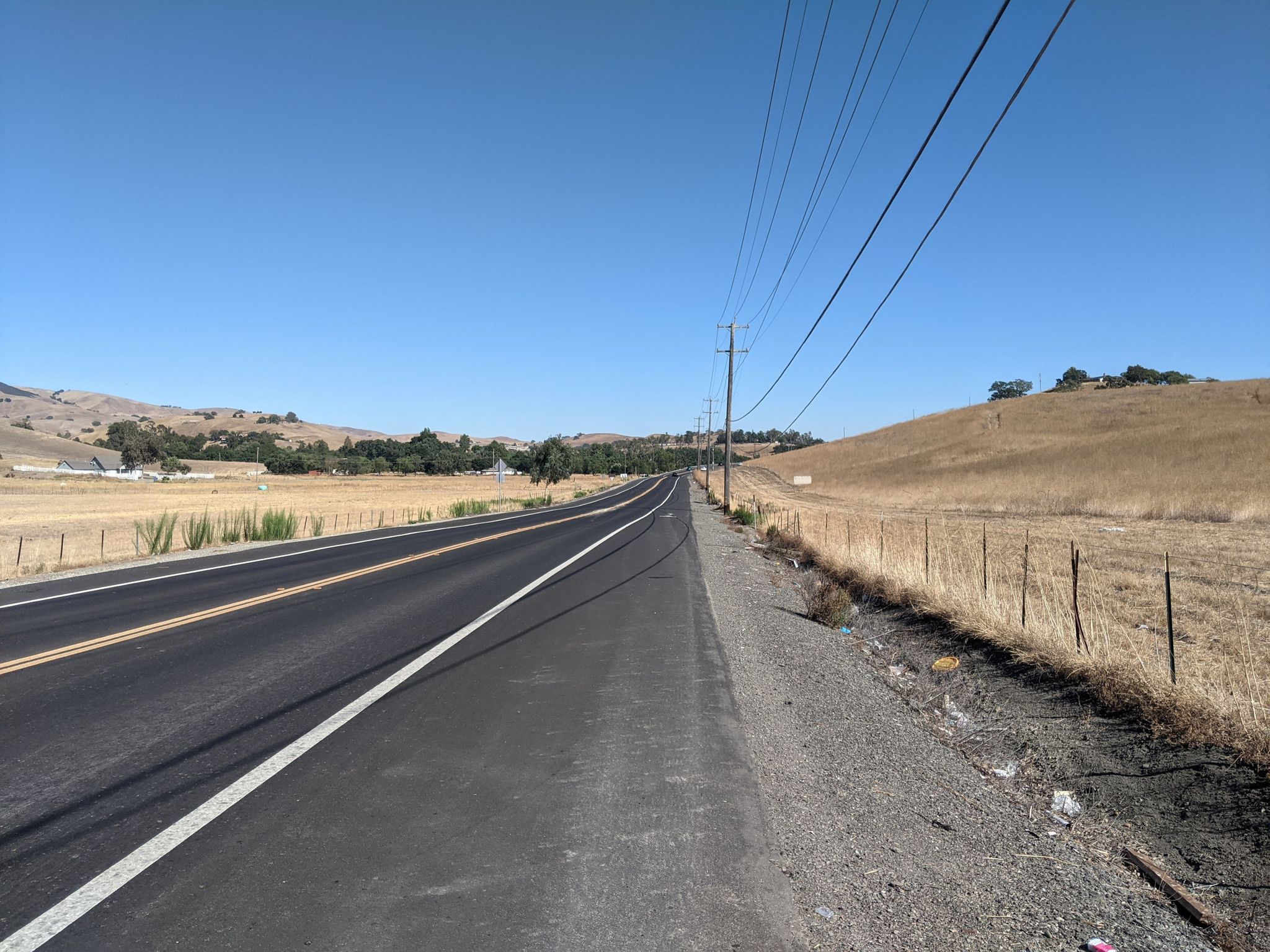 Paved road alongside dry golden hills under a bright blue sky. - Rolling Hills Trail loop from Dougherty Valley High School